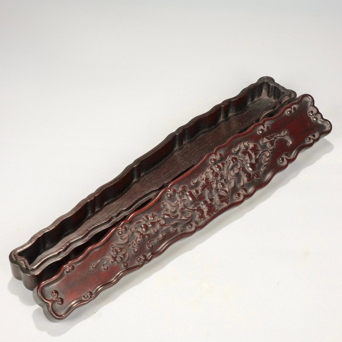 A Qing Dynasty red sour branch wood carved guqin-style Fulu pattern fan box (1 of 9)