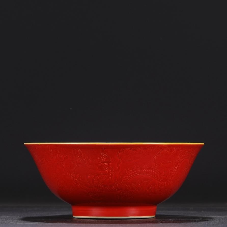 A large deep-bellied bowl with a yellow ground red glaze made in the Ming Dynasty and Chenghua year: The yellow ground red glaze made in the Chenghua year of the Ming Dynasty is secretly carved with seawater cloud dragon pattern deep-bellied large bowl Size:H:8cmCalibre19cm (The