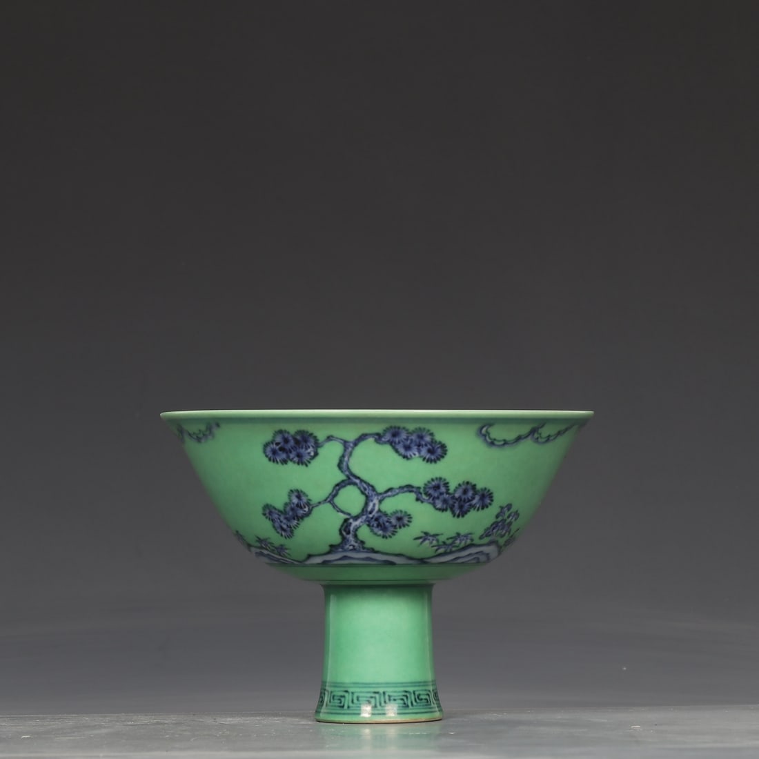 A green blue and white pine bamboo plum pattern goblet made in the Chenghua year of the Ming Dynasty: The green blue and white pine bamboo plum pattern goblet made in the Chenghua year of the Ming Dynasty Size:H:11.2cmCalibre:16cm (The Dimensions Of All Batches Are Manually