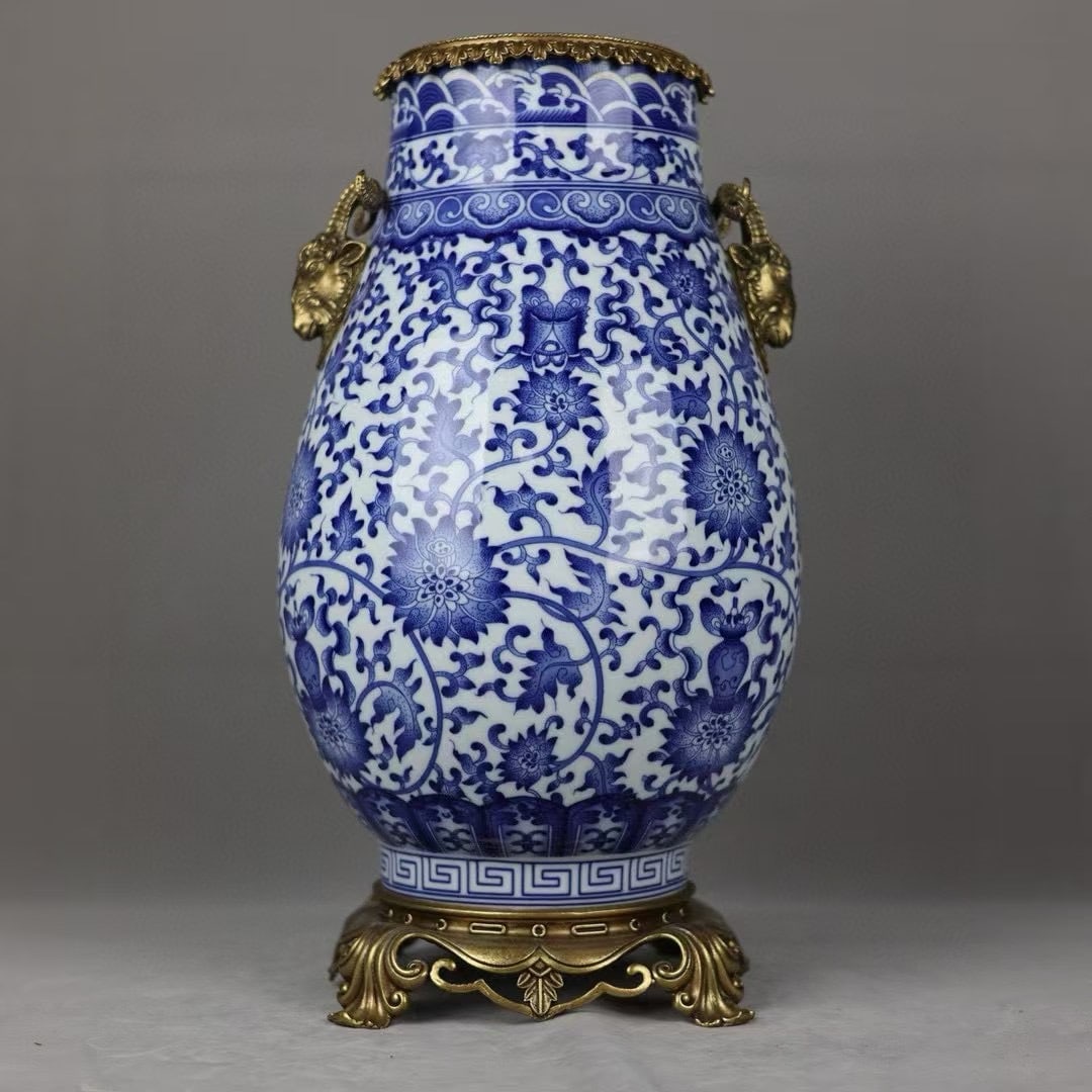 An Exquisite Blue and White Inlaid Bronze Lotus Pattern Double-Ears Vase: An Exquisite Blue and White Inlaid Bronze Lotus Pattern Double-Ears Vase Qing Dynasty, China Qianlong Six-character Mark Size:45.5cmx24cm (The Dimensions Of All Batches Are Manually Measured.If You