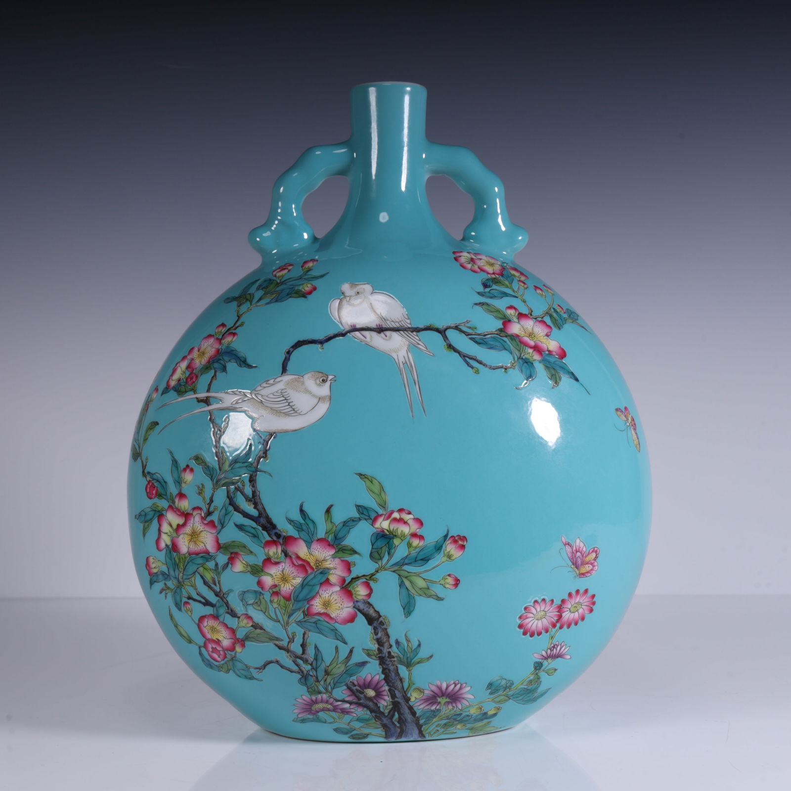 A Qing Dynasty Yongzheng year enamel green background painting bird flower double ear moon vase: The enamel green background painting bird flower binaural moon vase made in the Yongzheng era of the Qing Dynasty SIZE:L:21.5cm W:14cm H:30cm W:3.1kg (The Dimensions Of All Batches