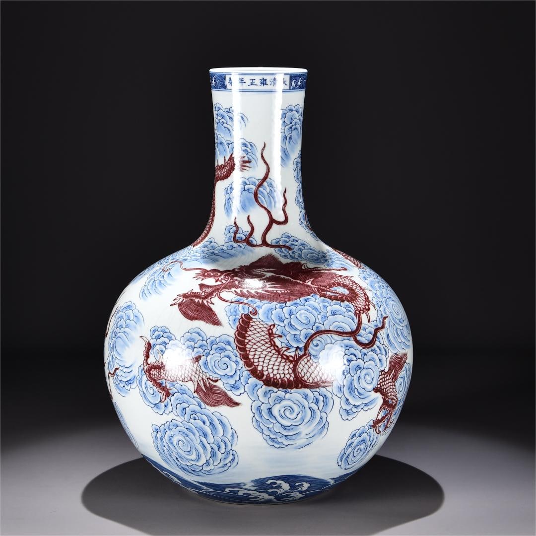 A blue and white glaze red auspicious cloud dragon pattern celestial ball bottle made in the: Qing Dynasty Yongzheng year blue and white glazed red auspicious cloud dragon pattern sky ball vase Size:H:53cm W:35cm (The Dimensions Of All Batches Are Manually Measured.If You