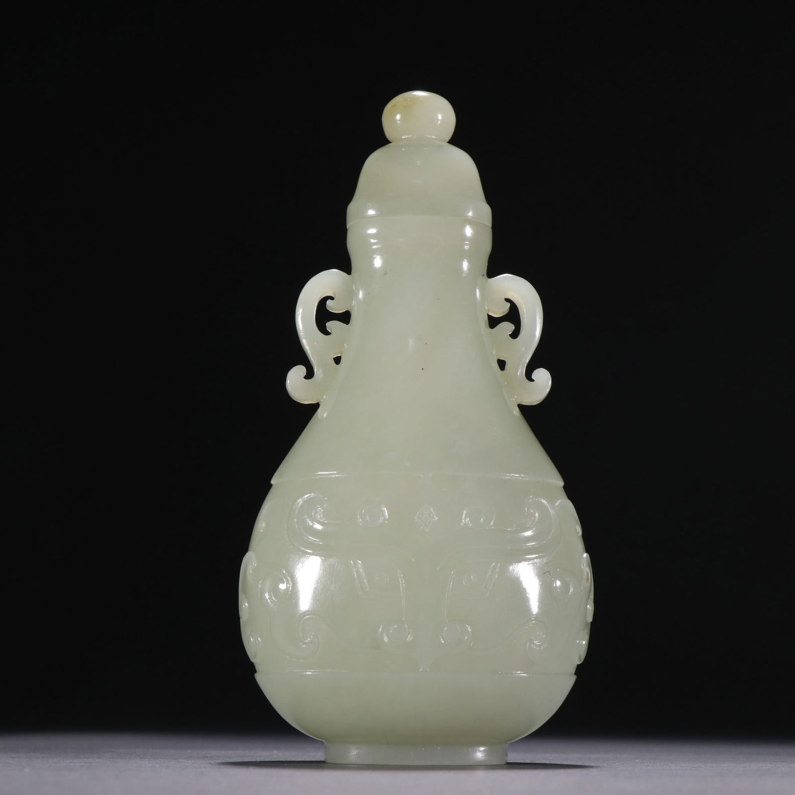 A Qing Dynasty Hetian jade gluttonous pattern lid bottle (1 of 9)