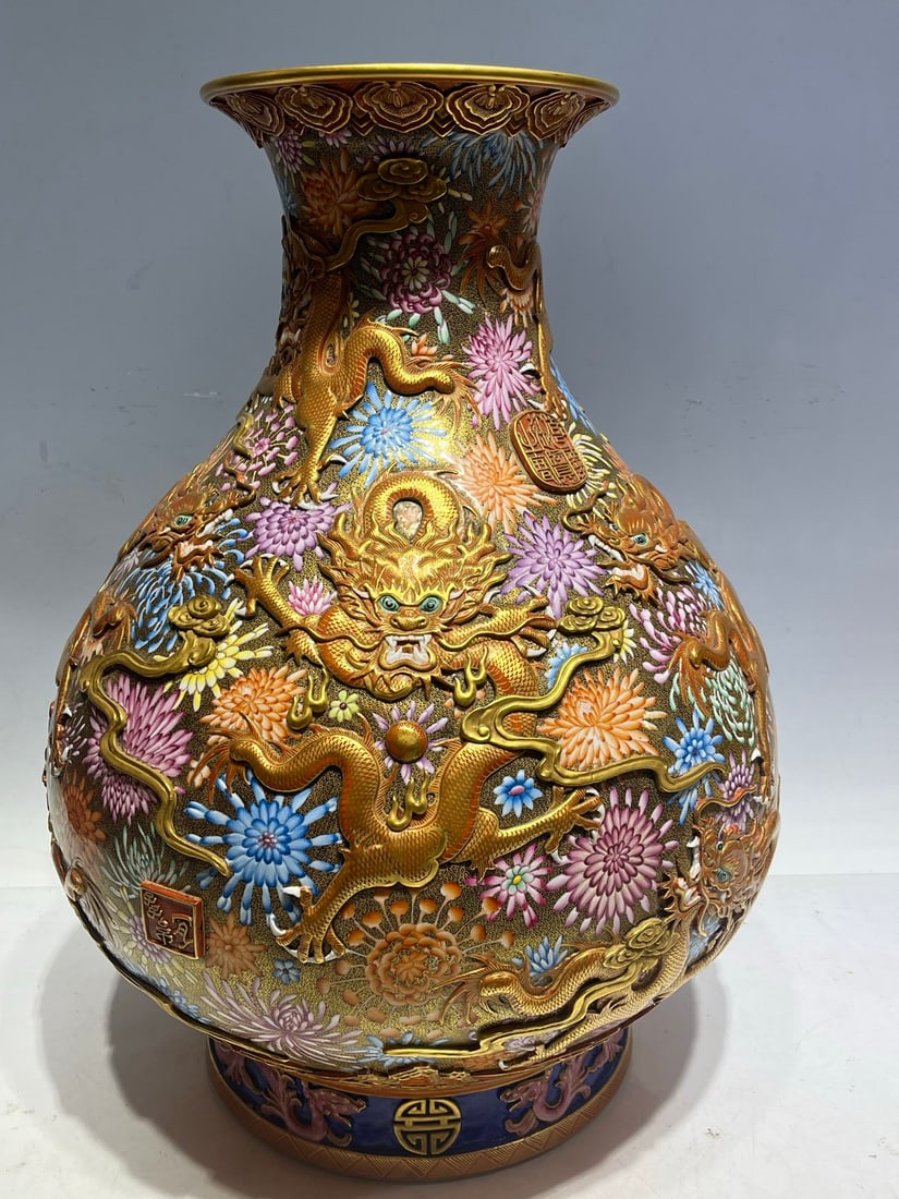 A fine enamel high-relief Kowloon patterned vase: Exquisite enamel color high relief Kowloon patterned vase Size:H:51cm Belly diameter:39cm Bottom:24.5cm (The Dimensions Of All Batches Are Manually Measured.If You Need More Detailed Information, Plea