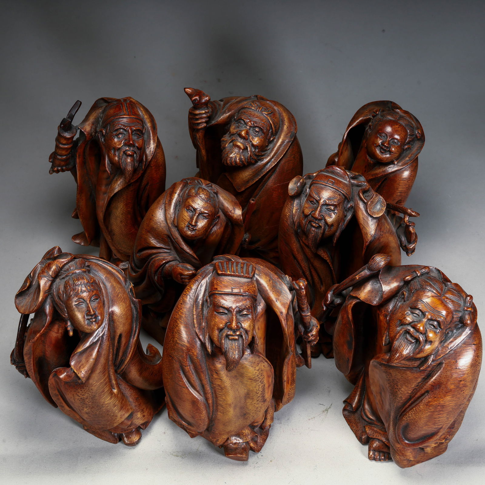 A bamboo root carving of the Eight Immortals figure ornament of the Qing Dynasty: Qing Dynasty bamboo root carving of the Eight Immortals figure ornament Size: H:16cm L: 9cm W:6cm W:185gH:17cm L: 11cm W:7cm W:274gH:16cm L: 11.5cm W:6cm W:351gH:15.5cm L: 10cm W:7cm
