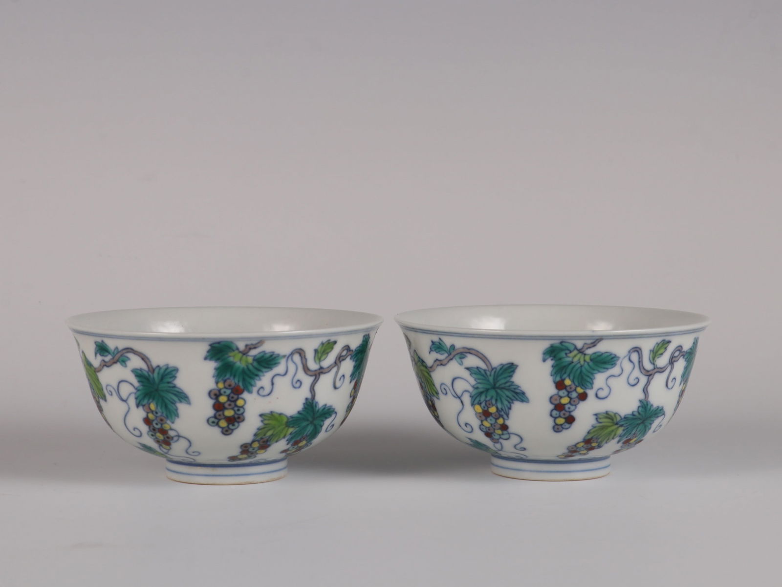 A Pair of Exquisite Doucai Grapes Pattern Cup: A Pair of Exquisite Doucai Grapes Pattern Cup Qing Dynasty, China Yongzheng Six-character Mark Size:5cmx9.3cm (The Dimensions Of All Batches Are Manually Measured.If You Need More Detailed
