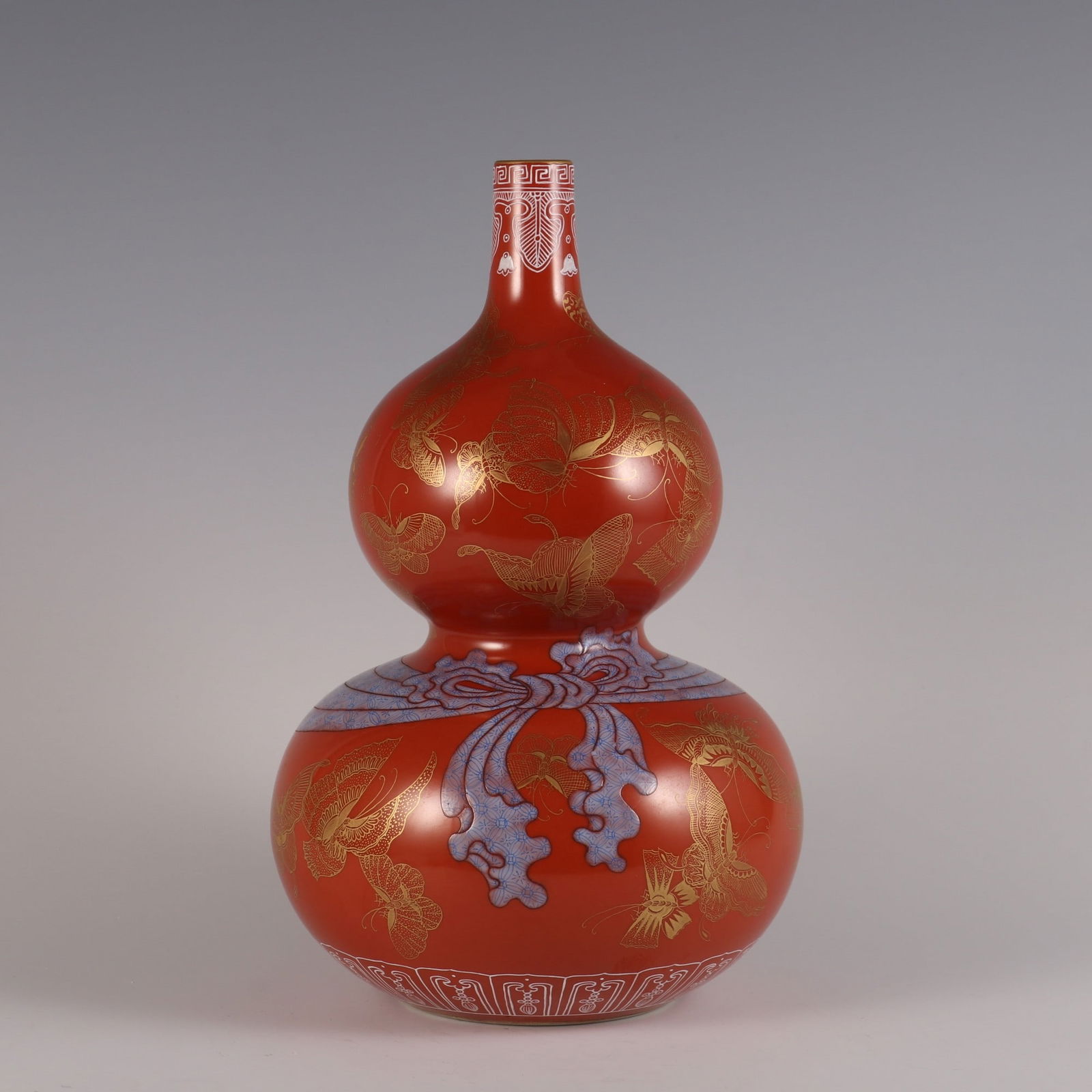 An Exquisite Coral Red Glazed Painted Gold Butterfly Pattern Gourd-Shaped Vase: An Exquisite Coral Red Glazed Painted Gold Butterfly Pattern Gourd-Shaped Vase Qing Dynasty, China Qianlong Six-character Mark Size:31.5cmx19cm (The Dimensions Of All Batches Are Manually