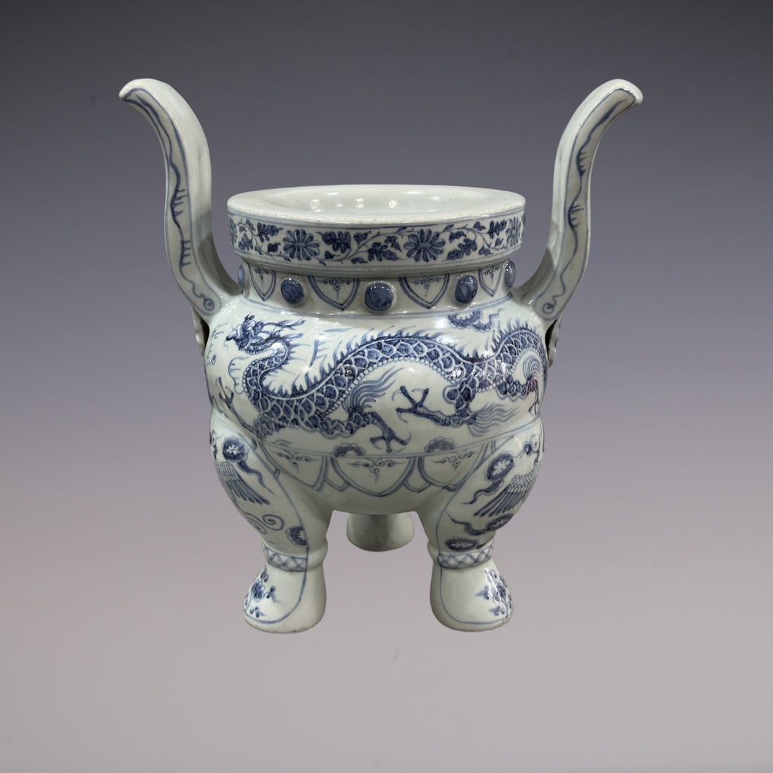 An Exquisite Blue and White Lotus Pattern Dragon Pattern Double-Ears and Tripod Censer: An Exquisite Blue and White Lotus Pattern Dragon Pattern Double-Ears and Tripod Censer Yuan Dynasty, China Size:48.5cmx45cm (The Dimensions Of All Batches Are Manually Measured.If You Need More