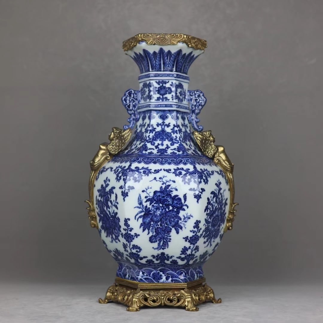 An Exquisite Blue and White Inlaid Bronze Bats and Peach Pattern Seawater Pattern Double-Ears Vase: An Exquisite Blue and White Inlaid Bronze Bats and Peach Pattern Seawater Pattern Double-Ears Vase Qing Dynasty, China Qianlong Six-character Mark Size:46cmx25cm (The Dimensions Of All Batches Are