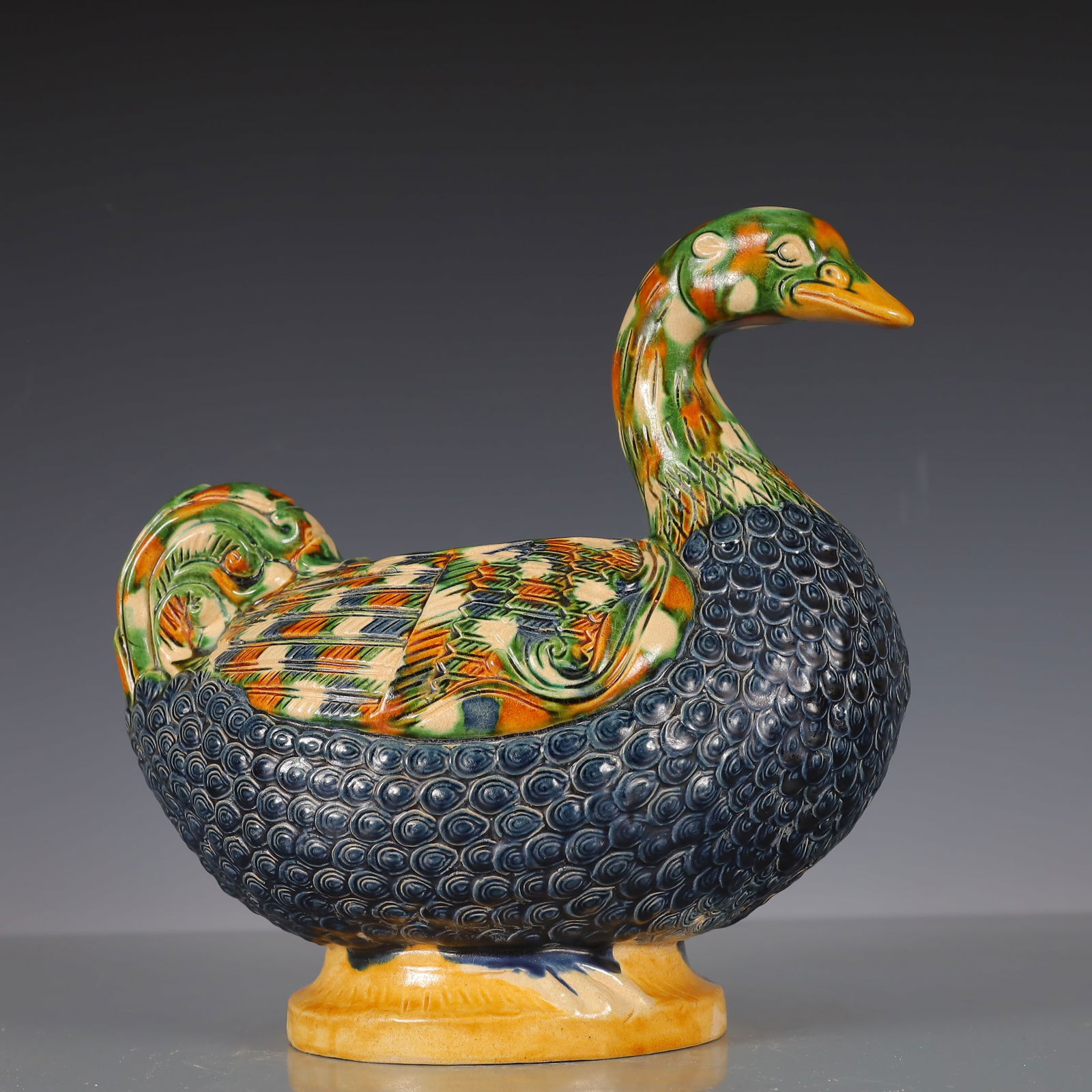A Exquisite Trio-colored glazed pottery of the Tang Dynasty Duck-Form Jar: A Exquisite Trio-colored glazed pottery of the Tang Dynasty Duck-Form Jar Tang Dynasty, China Size:26cmx16cmx24cm Weight:1500g (The Dimensions Of All Batches Are Manually Measured.If You Need More