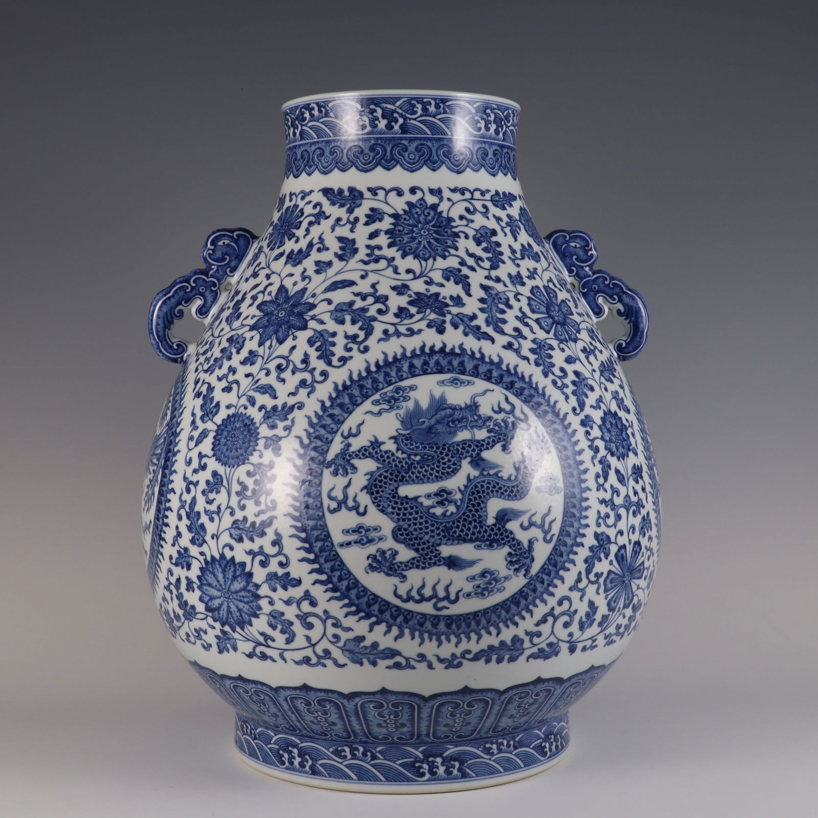 An Exquisite Blue and White Lotus Pattern Dragon and Phoenix Pattern Seawater Pattern Double-Ears: An Exquisite Blue and White Lotus Pattern Dragon and Phoenix Pattern Seawater Pattern Double-Ears Vase Qing Dynasty, China Qianlong Six-character Mark Size:46.8cmx36cm (The Dimensions Of All