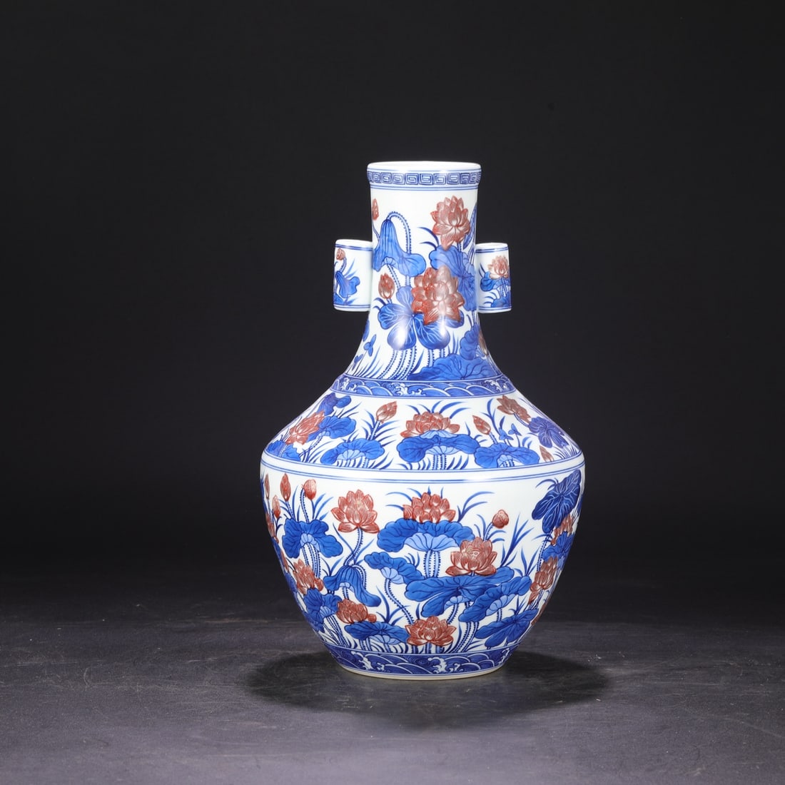 A blue and white glazed red lotus pond pattern large ear bottle made in the Qianlong period of the: Qing Dynasty Qianlong year blue and white glaze red lotus pond pattern large ear piercing bottle Size:H:33cmCalibre7cmBelly diameter20.5cm (The Dimensions Of All Batches Are