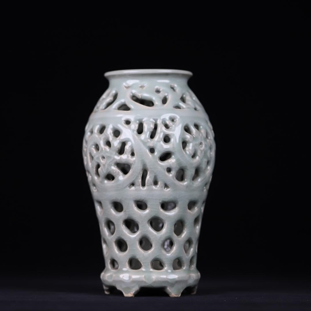 A Yuan Dynasty celadon hollow carved tangled pattern vase: Yuan Dynasty celadon hollow carved tangled pattern bottle Size:H:25cmx13cm (The Dimensions Of All Batches Are Manually Measured.If You Need More Detailed Information, Please Contact