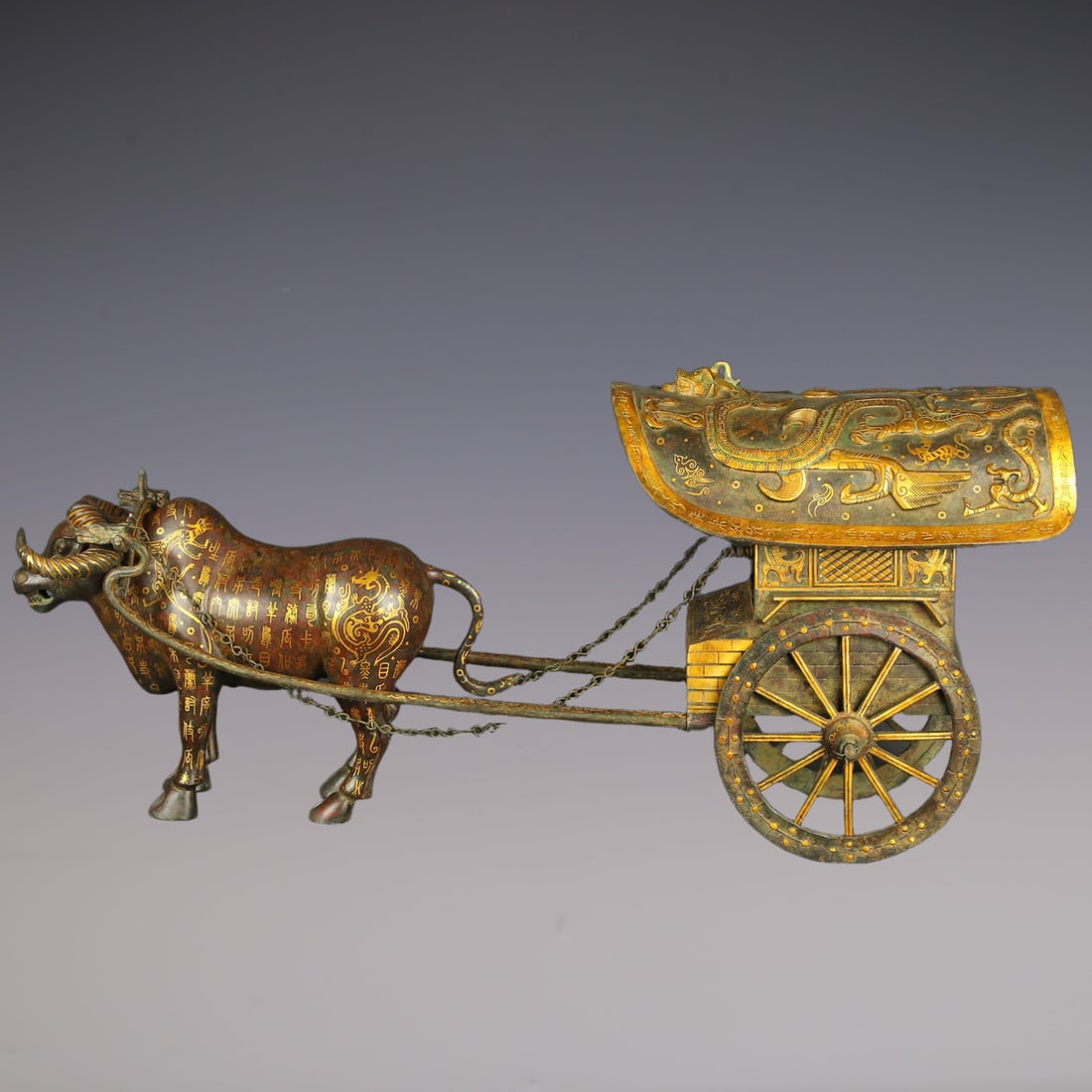 An Exquisite Bronze Inlaid Gold Chi-Dragon Pattern With Inscription Ox cart Ornament: An Exquisite Bronze Inlaid Gold Chi-Dragon Pattern With Inscription Ox cart Ornament Han Dynasty, China Size:92cmx42cm Weight:19050g (The Dimensions Of All Batches Are Manually Measured.If You Need