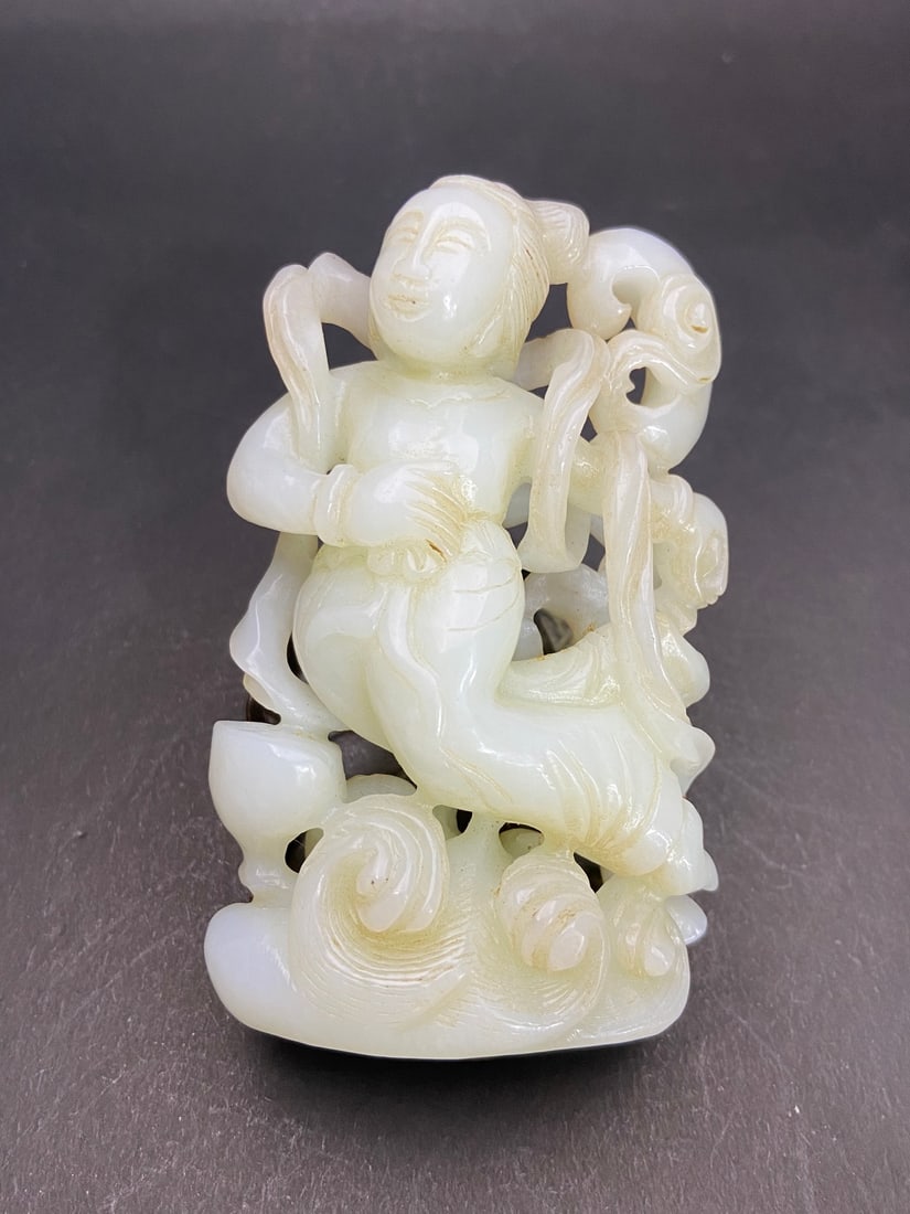 An Exquisite White Jade Figure Ornament: An Exquisite White Jade Figure Ornament Tang Dynasty, China Size:93.6mmx60mmx26.8mm Weight:177g (The Dimensions Of All Batches Are Manually Measured.If You Need More Detailed Information, Please