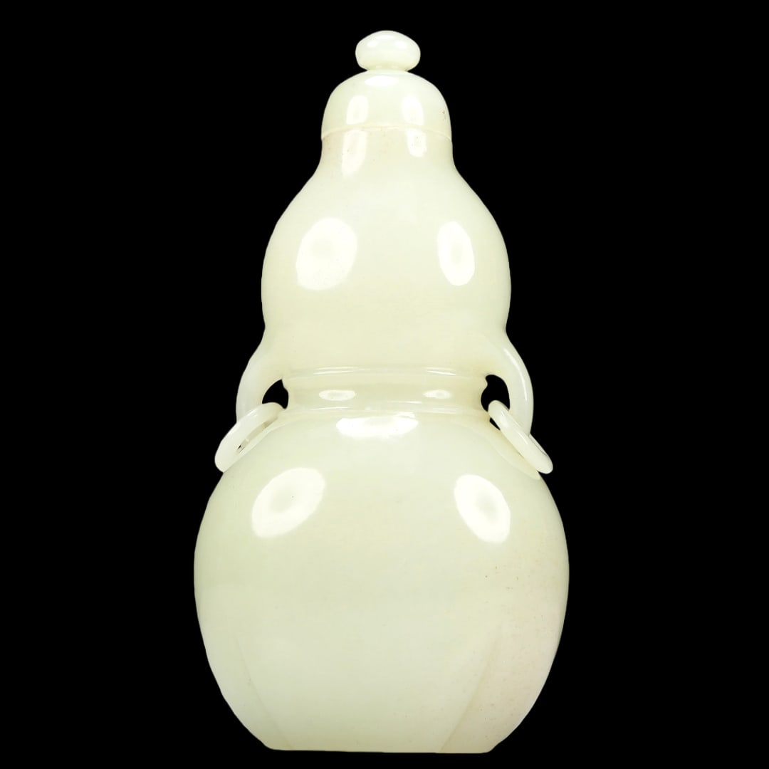 A Superb White Jade Gourd-Form Vase: A Superb White Jade Gourd-Form Vase. Handles with suspending, loose rings. Chinese Qing Dynasty. Size:7cmx4.5cmx14.5cm. Weight:285g (The Dimensions Of All Batches Are Manually Measured.If You Need