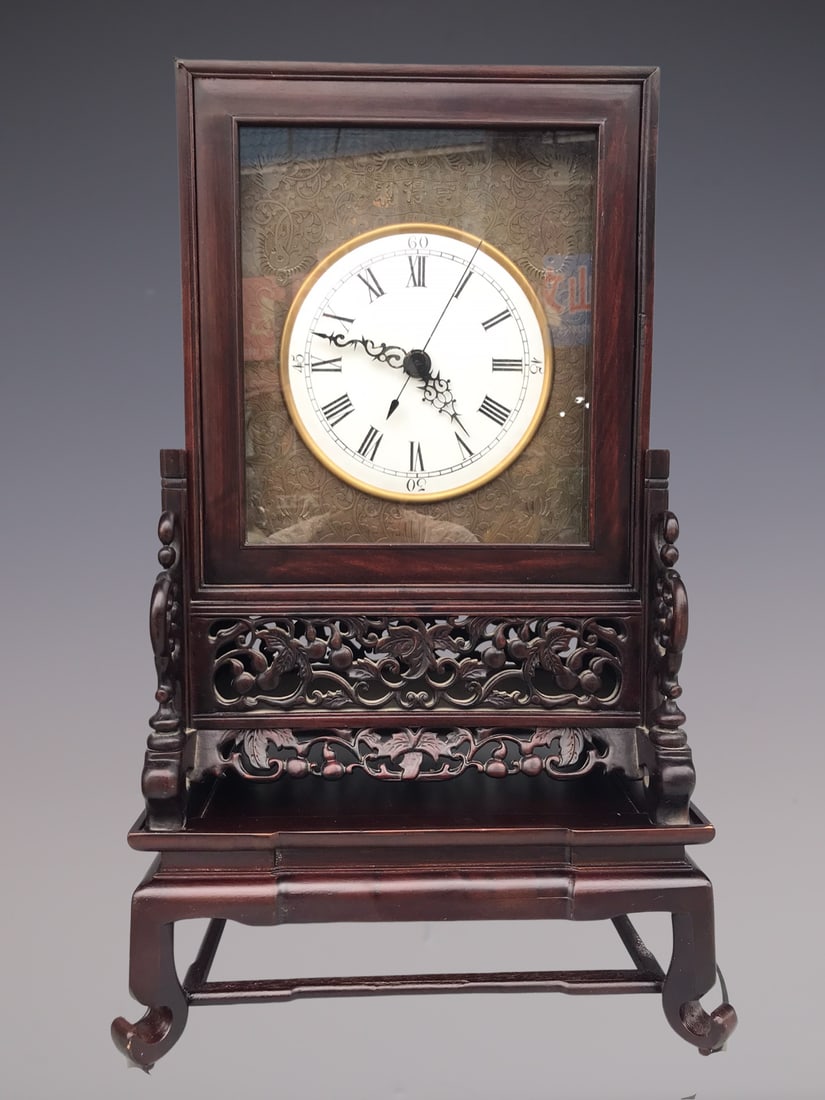 An Exquisite Bronze Inlaid Redwood Lotus Pattern Clock: An Exquisite Bronze Inlaid Redwood Lotus Pattern Clock Qing Dynasty, China Size:64cmx38cmx29cm (The Dimensions Of All Batches Are Manually Measured.If You Need More Detailed Information, Please