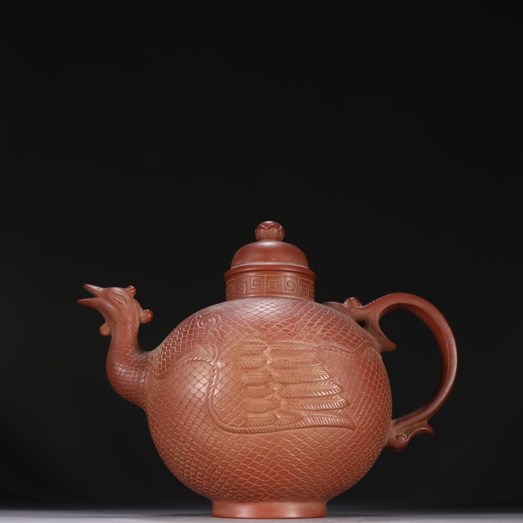 An Exquisite Purple Sands Phoenix Pattern Teapot: An Exquisite Purple Sands Phoenix Pattern Teapot Qing Dynasty, China Size:18cmx23cm (The Dimensions Of All Batches Are Manually Measured.If You Need More Detailed Information, Please Contact Our Custo