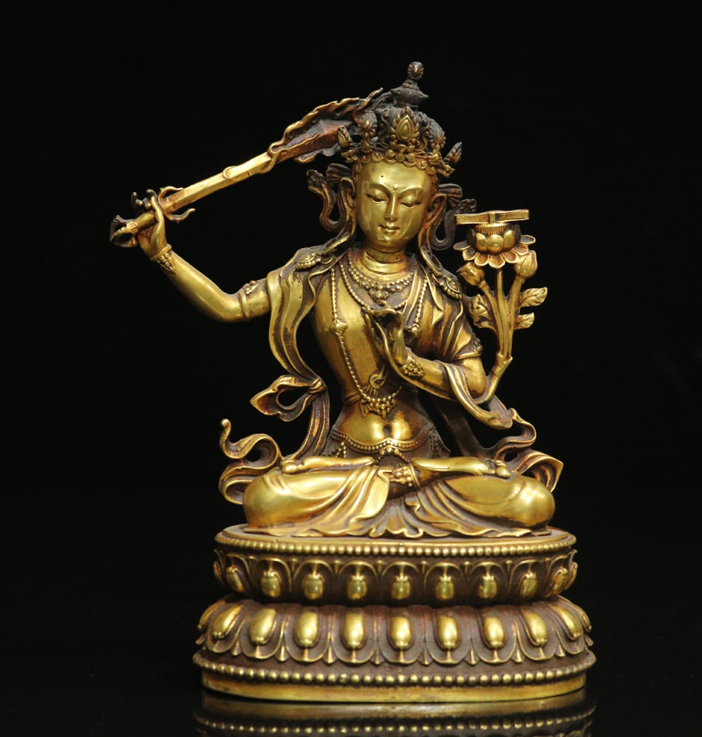 An Exquisite Gilt Bronze Four-arms Statue of Manjusri Ornament: An Exquisite Gilt Bronze Four-arms Statue of Manjusri Ornament Ming Dynasty, China Yongle Four-character Mark Size:15.5cmx9.5x7cm Weight:1055g (The Dimensions Of All Batches Are Manually