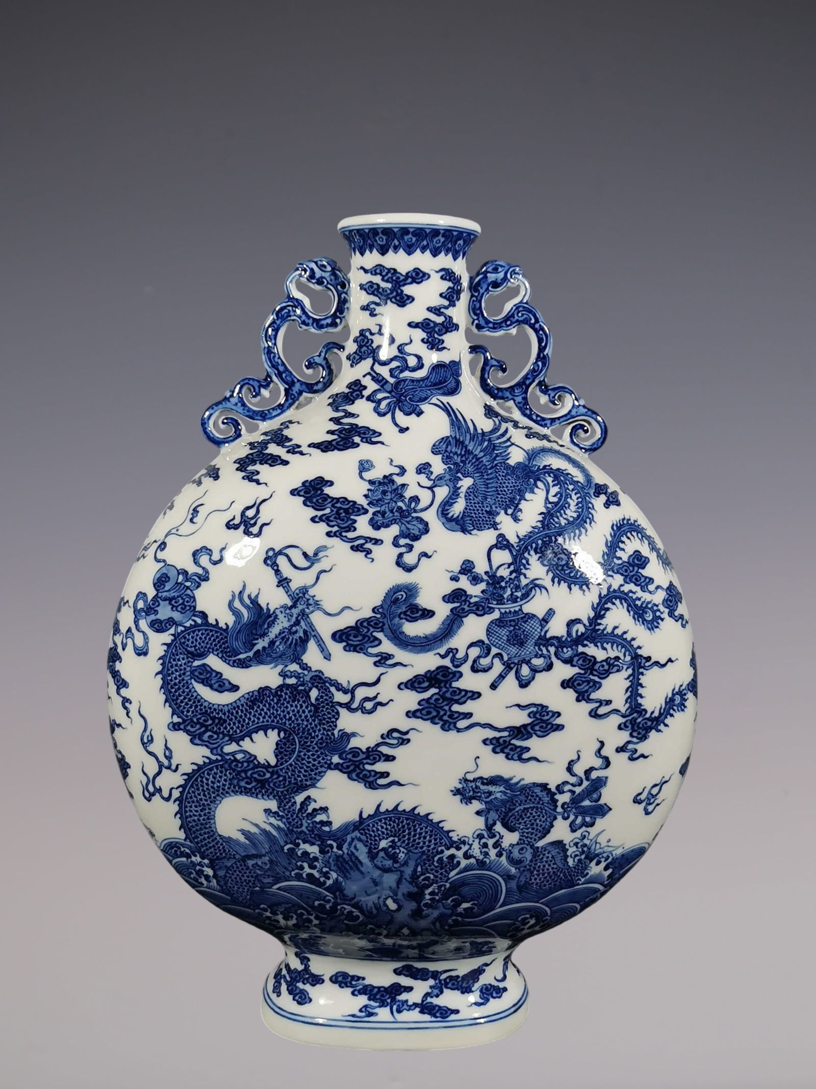 An Exquisite Blue and White Dragon and Phoenix Pattern Seawater Pattern Double-Ears Vase: An Exquisite Blue and White Dragon and Phoenix Pattern Seawater Pattern Double-Ears Vase Qing Dynasty, China Qianlong Six-character Mark Size:43cmx30.3cm (The Dimensions Of All Batches Are Manually