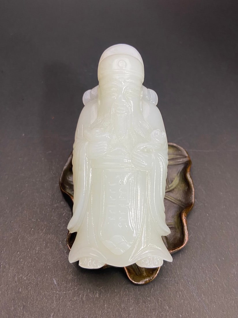 An Exquisite White Jade Statue of Mammon Hand Piece: An Exquisite White Jade Statue of Mammon Hand Piece Qing Dynasty, China Size:8.26cmx4.07cmx1.66cm Weight:93g (The Dimensions Of All Batches Are Manually Measured.If You Need More Detailed