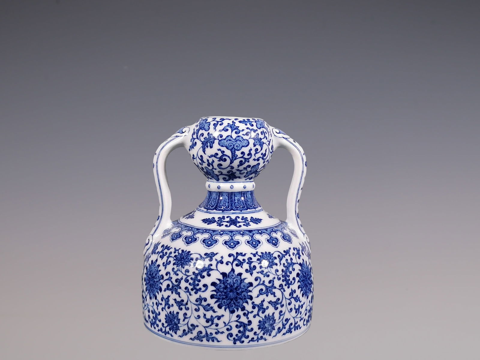 An Exquisite Blue and White Lotus Pattern Double-Ears Vase: An Exquisite Blue and White Lotus Pattern Double-Ears Vase Qing Dynasty, China Qianlong Six-character Mark Size:18.3cmx15cm (The Dimensions Of All Batches Are Manually Measured.If You Need More