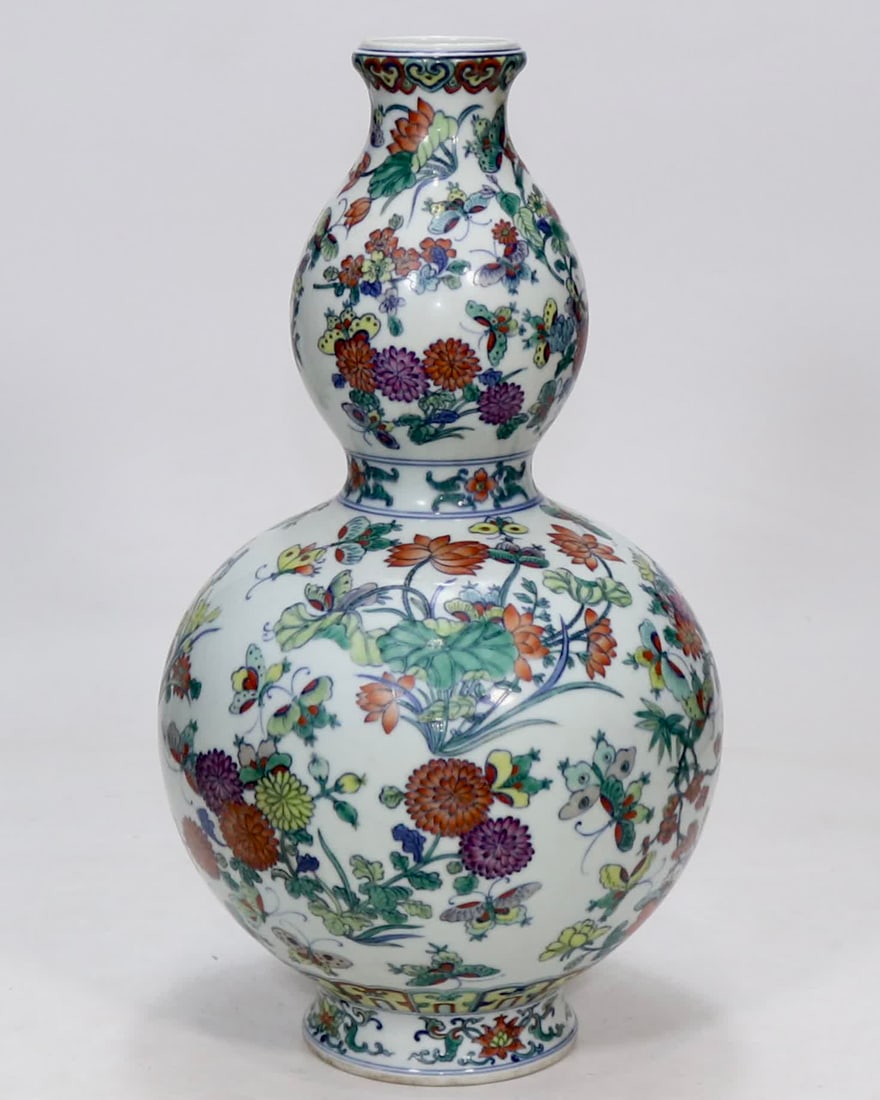 A Qing Qianlong year Doucai hundred flower gourd bottle: Qing Qianlong year made Doucai hundred flower gourd bottles SIZE: H:38.6cm (The Dimensions Of All Batches Are Manually Measured.If You Need More Detailed Information, Please Contact Our Customer Servi