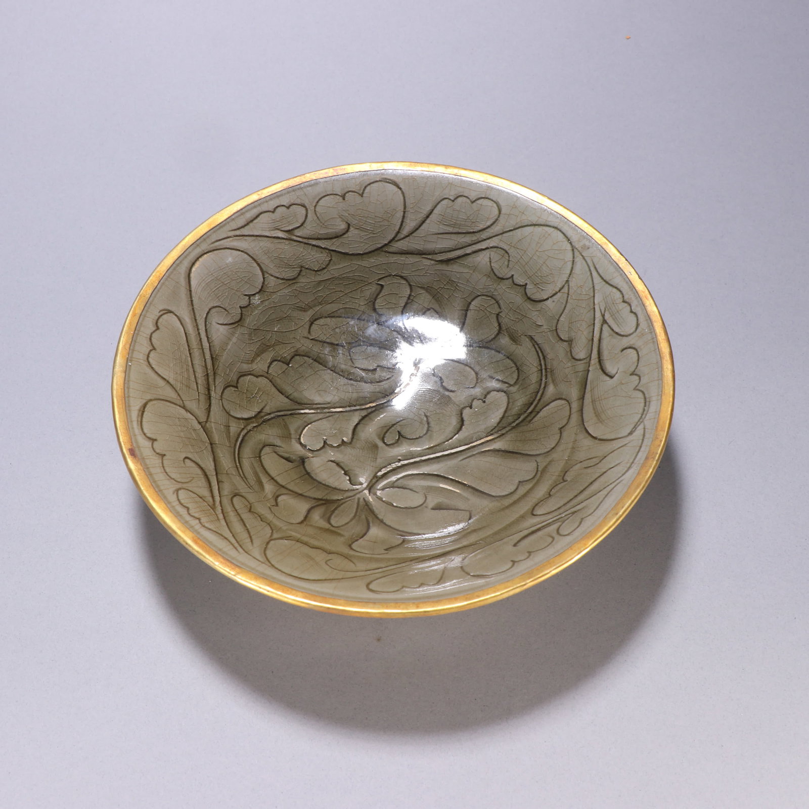 A Yaozhou kiln wrapped gold carved hat bowl: Yaozhou kiln wrapped gold carved hat bowl SIZE: H:5.1cm W:19.5cm (The Dimensions Of All Batches Are Manually Measured.If You Need More Detailed Information, Please Contact Our Customer Service Before