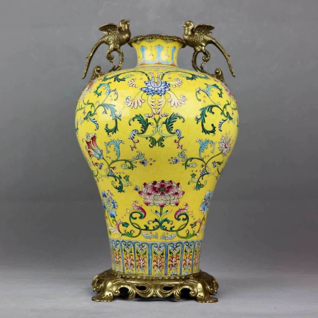 A Qing Dynasty yellow pastel entwined lotus inlaid with copper flower and bird ear plum vase: Qing Dynasty yellow pastel entwined lotus inlaid with copper flower bird ear plum vase SIZE: H: 48cm mouthD: 9cm D: 24cm Bottom diameter 20.5cm (The Dimensions Of All Batches Are Manually