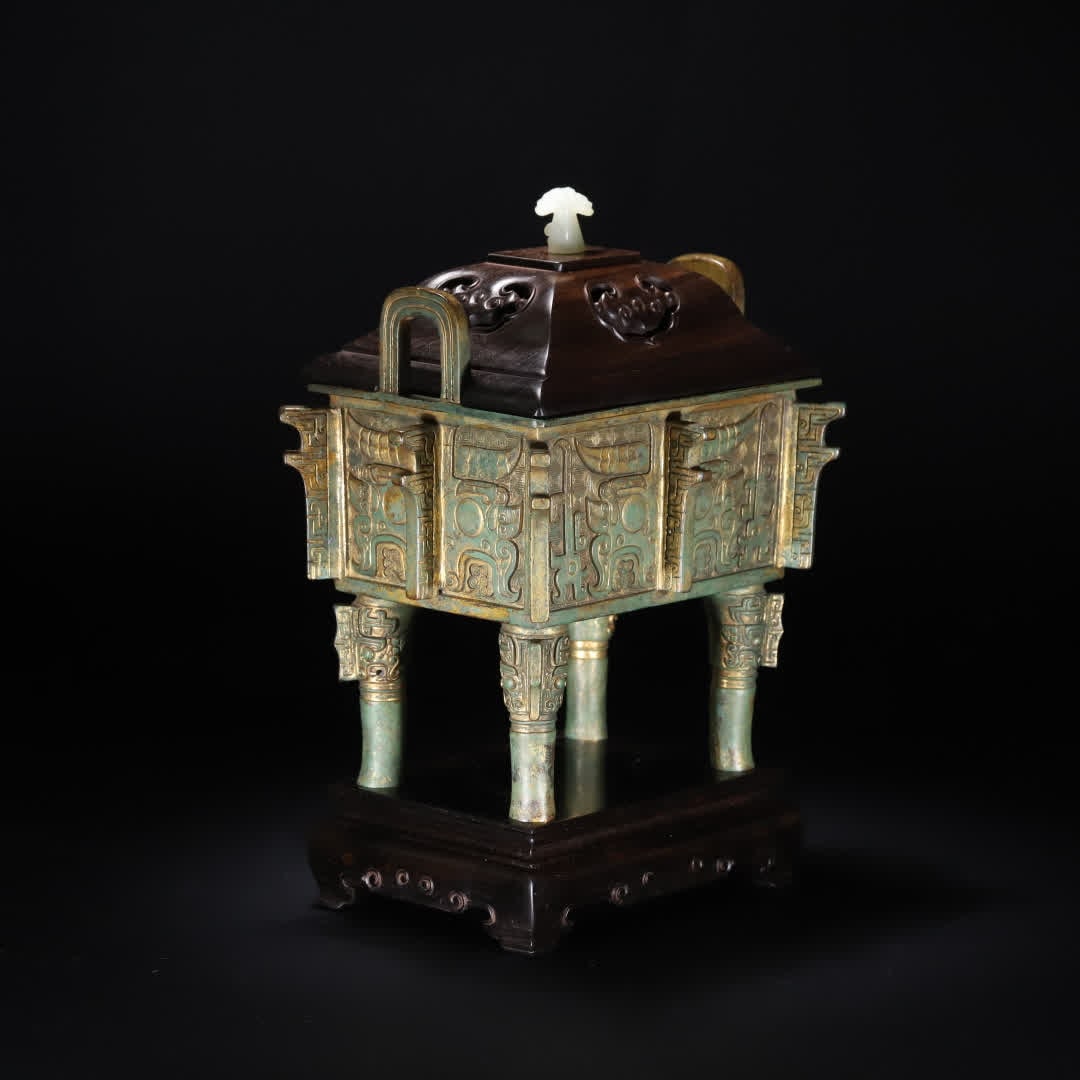 A Ming Dynasty copper gilt gluttonous pattern tripod: The Ming Dynasty copper gilt gluttonous pattern tripod This tripod is an antique ceremonial vessel during the Chenghua period of the Ming Dynasty, the whole body is gilded, the shape is like a star, t