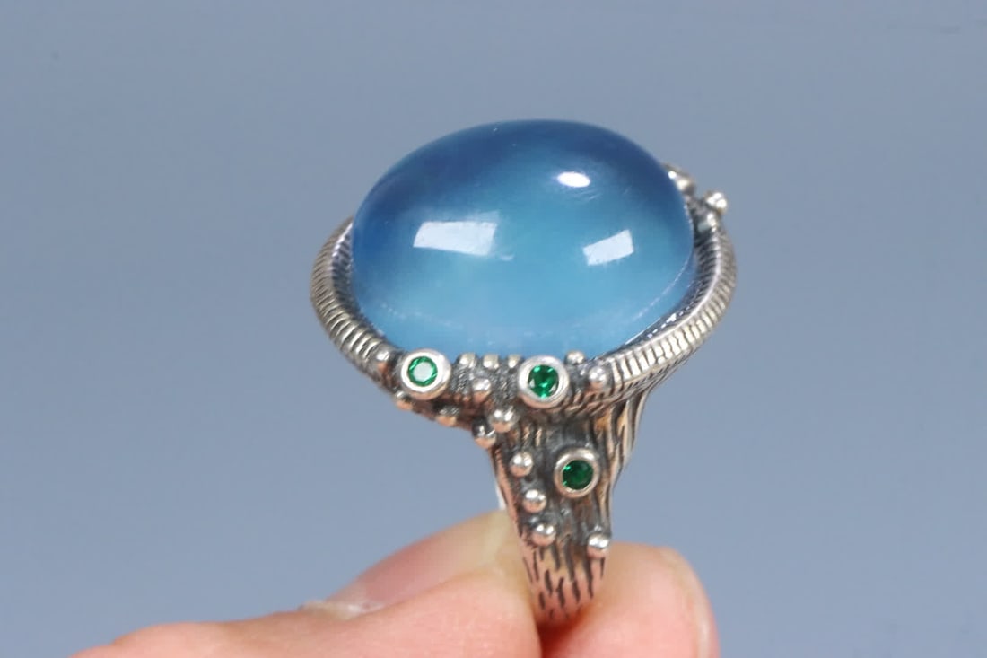 A silver support aquamarine ring on the face - 10