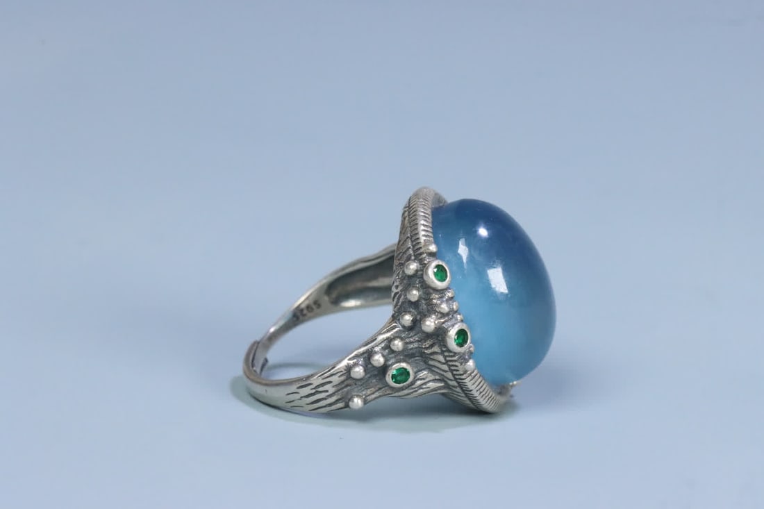 A silver support aquamarine ring on the face - 2