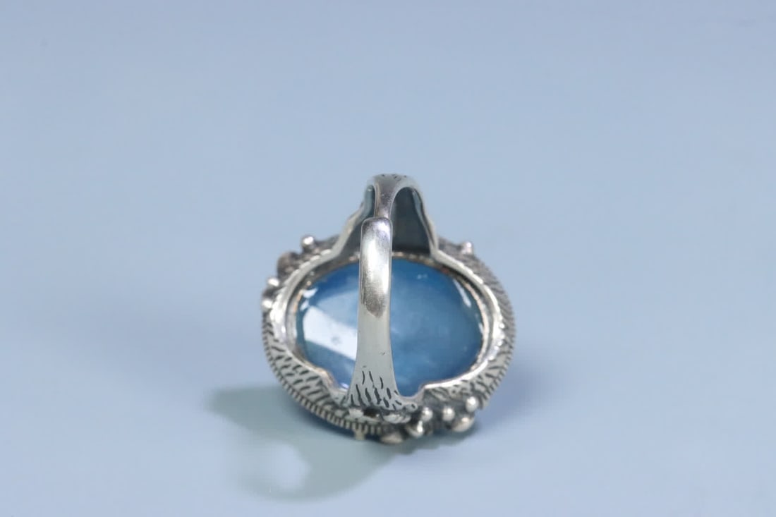 A silver support aquamarine ring on the face - 6