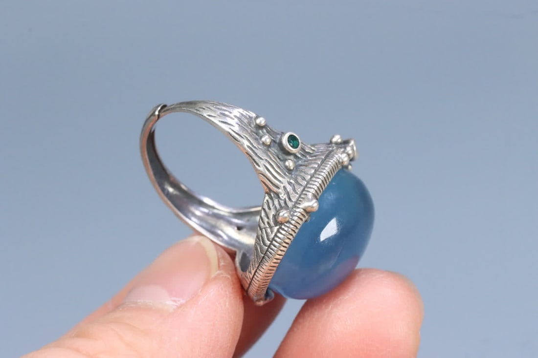 A silver support aquamarine ring on the face - 7