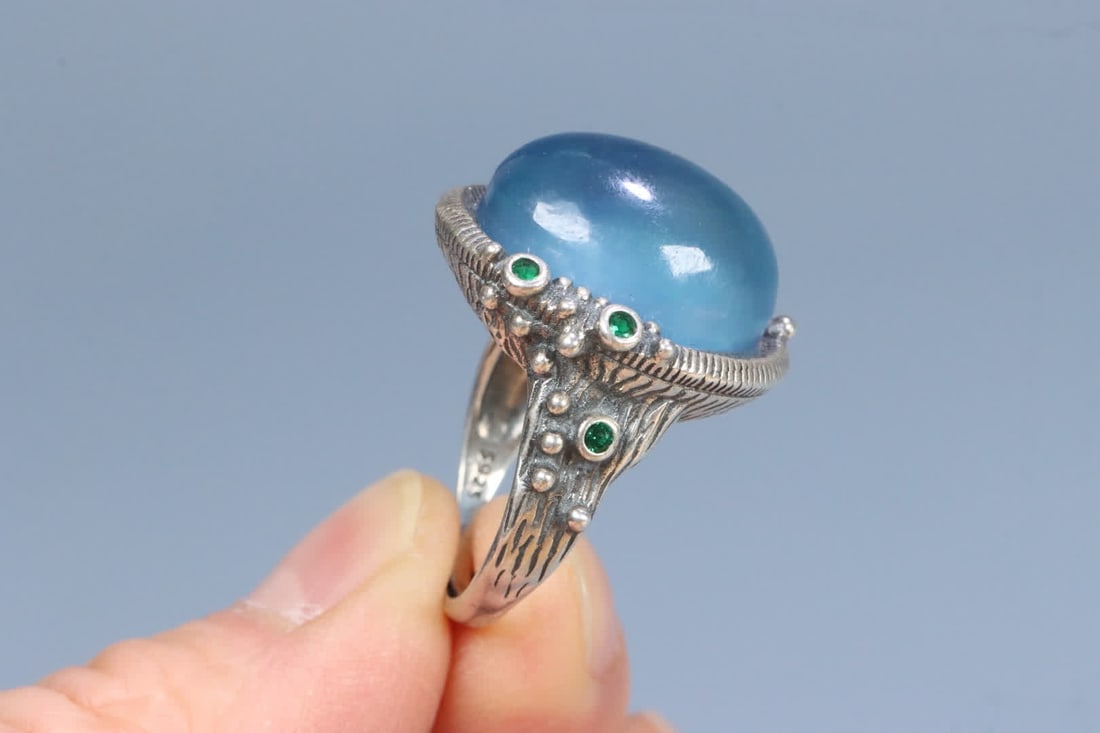 A silver support aquamarine ring on the face - 8