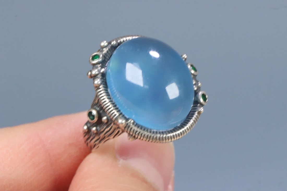 A silver support aquamarine ring on the face - 9