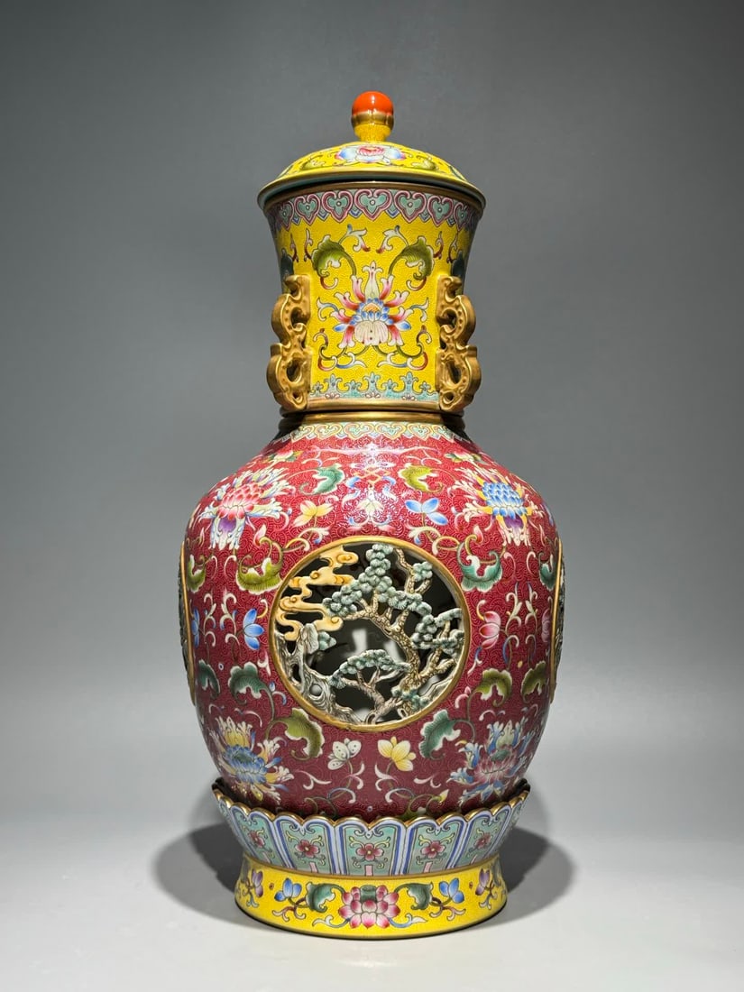 A Qing Qianlong style of foreign color red and yellow ground rolled road pattern entwined lotus with: Qing Qianlong style foreign color red and yellow ground rolled road pattern entwined lotus on all sides hollow plum pine four-ear turnstile core bottle SIZE: H:40cm W:20cm (The Dimensions Of All