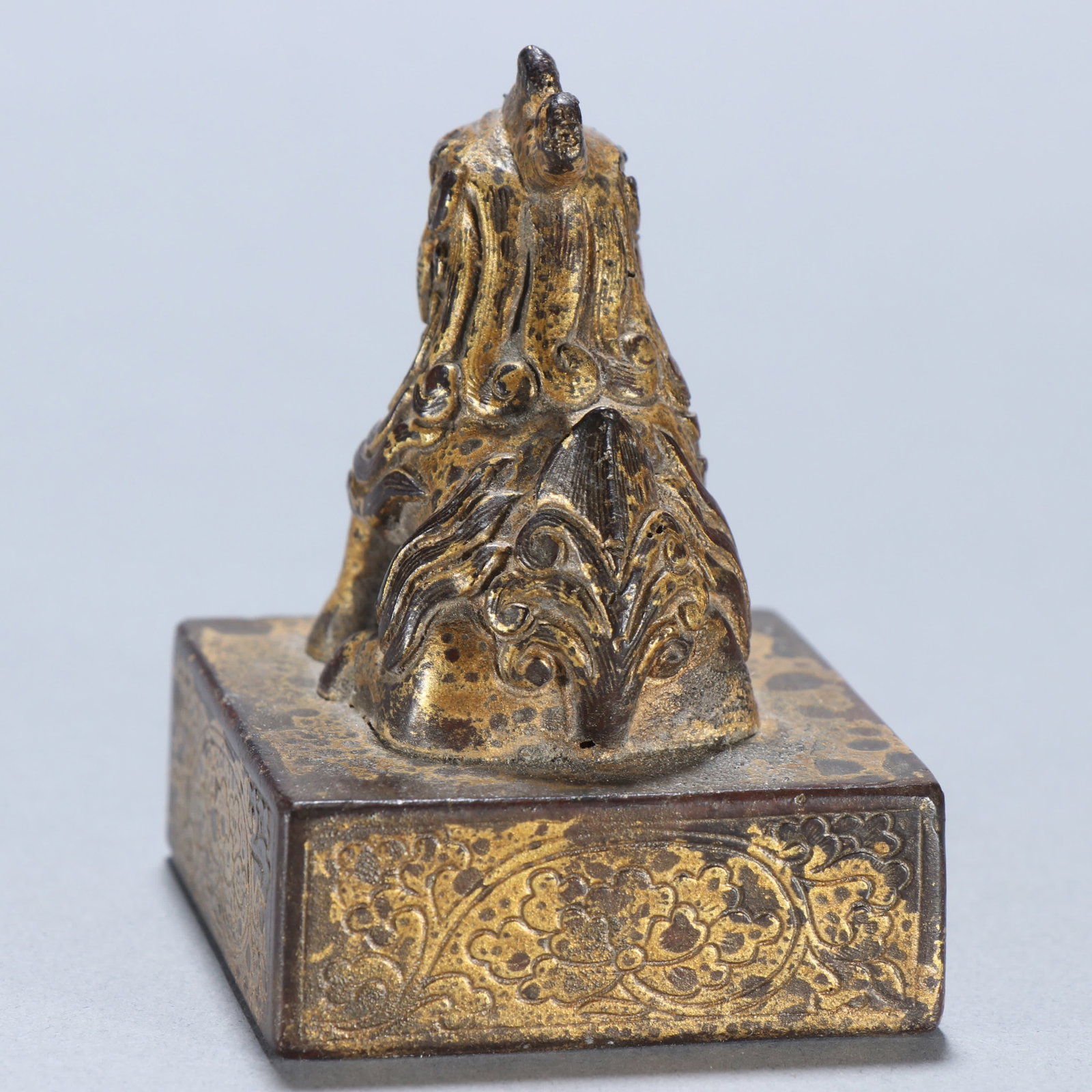 A copper gilt beast button seal - 3