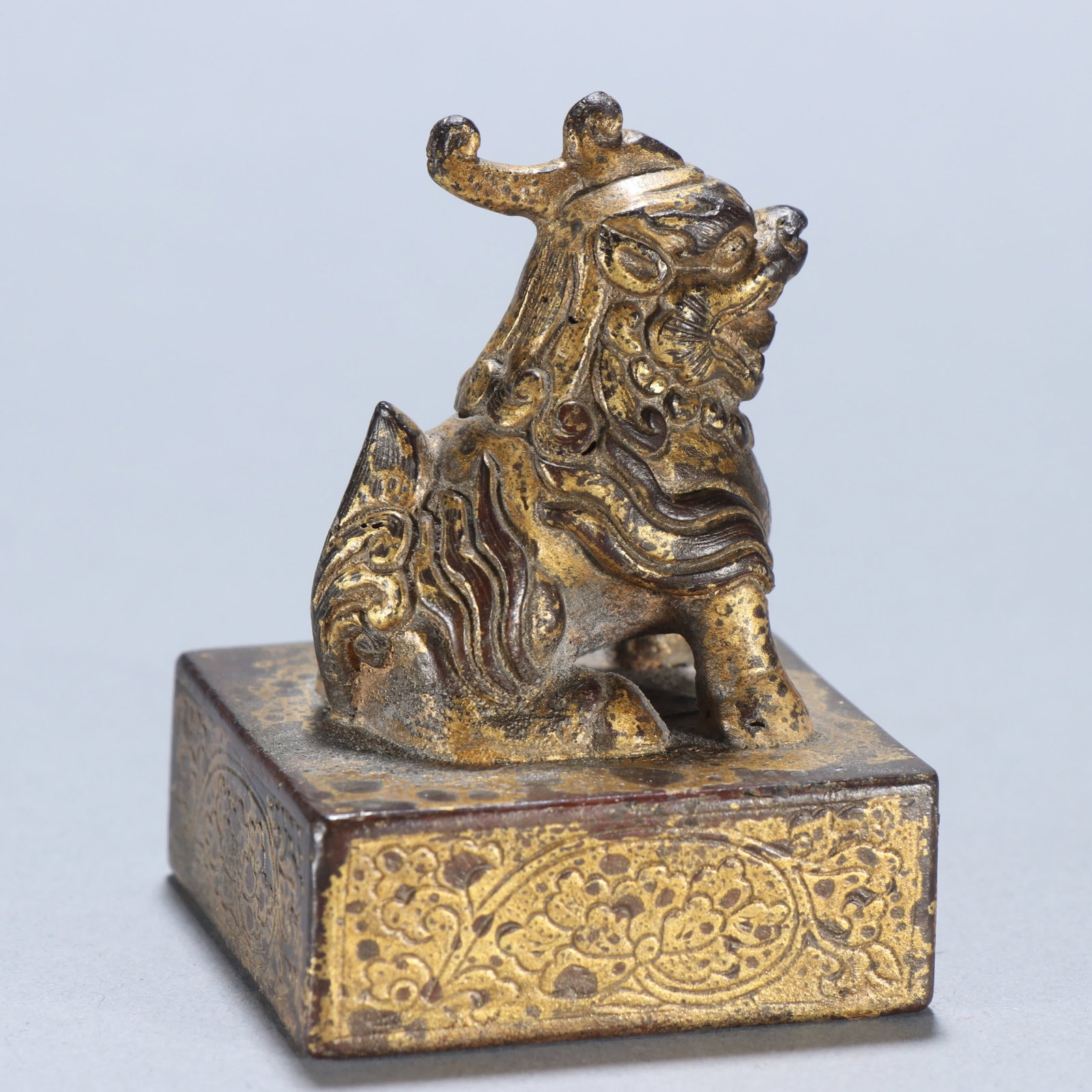 A copper gilt beast button seal - 5