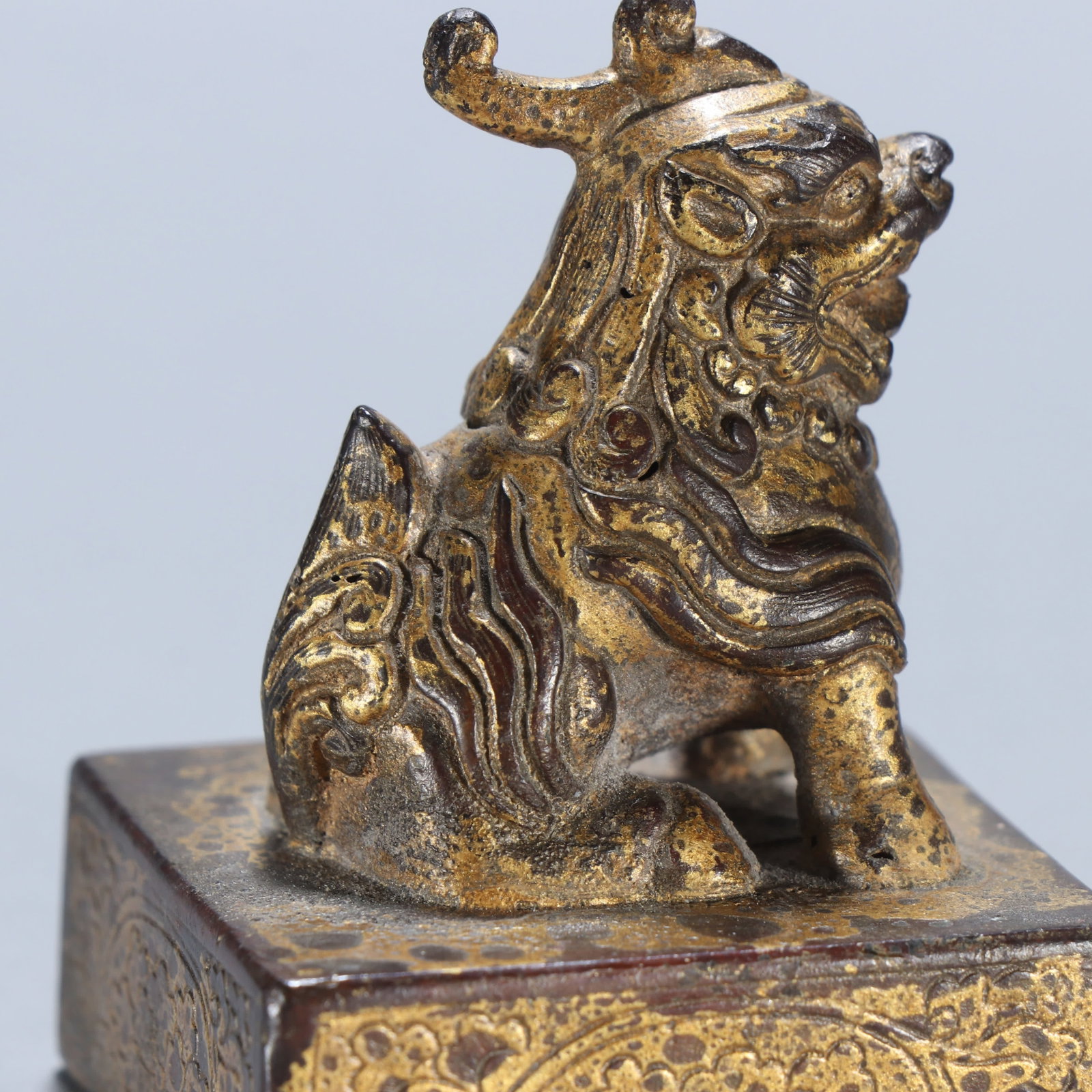 A copper gilt beast button seal - 6