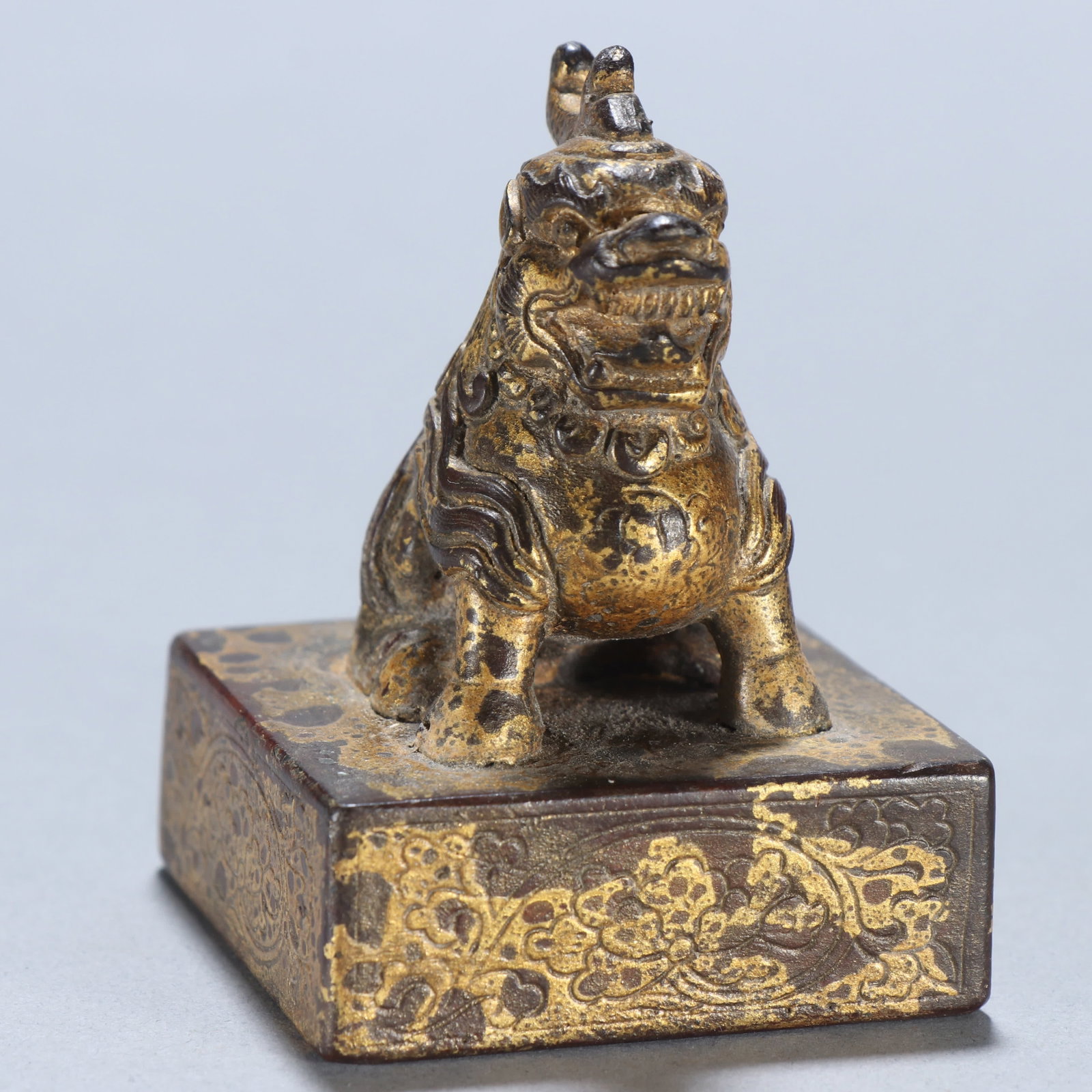 A copper gilt beast button seal - 7