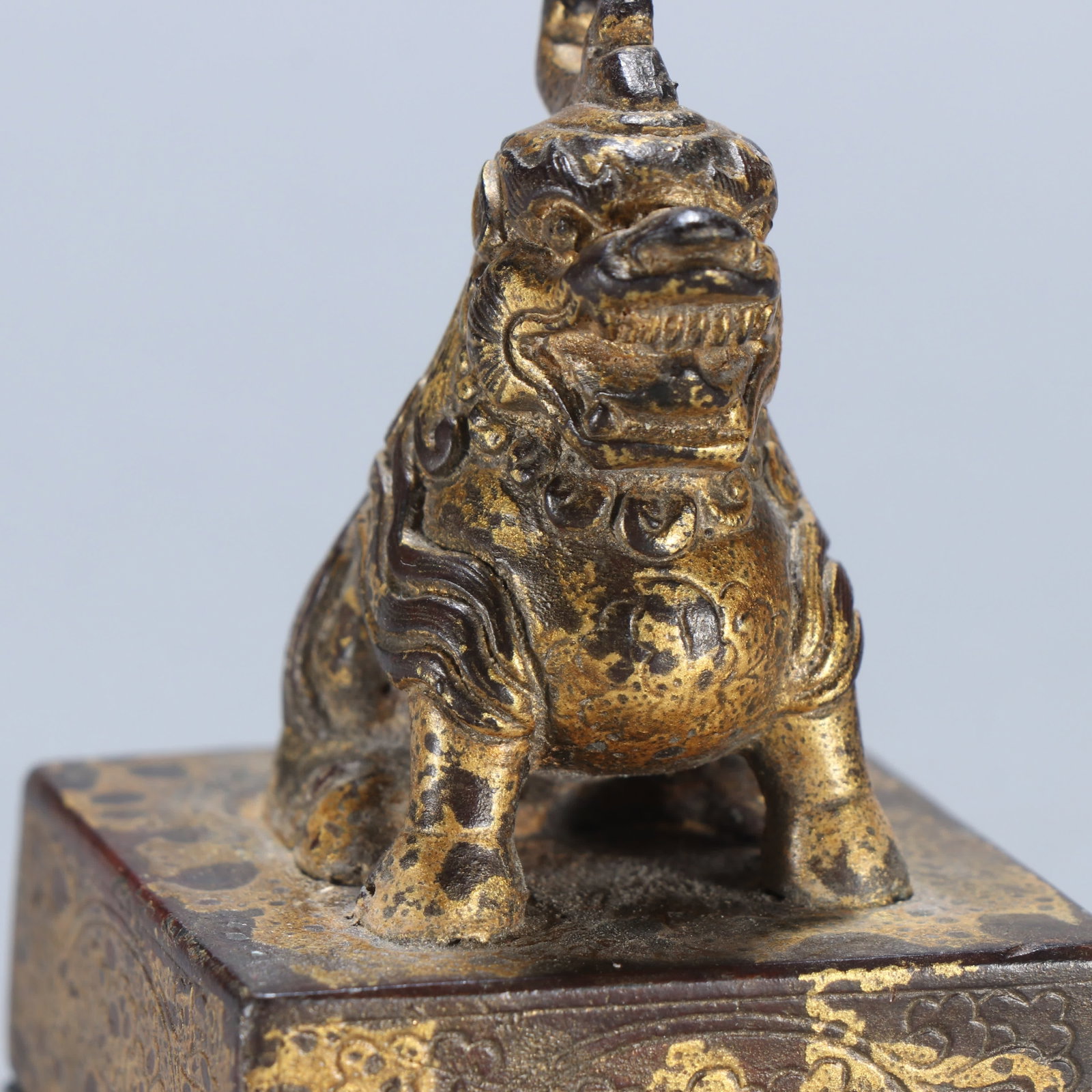 A copper gilt beast button seal - 8