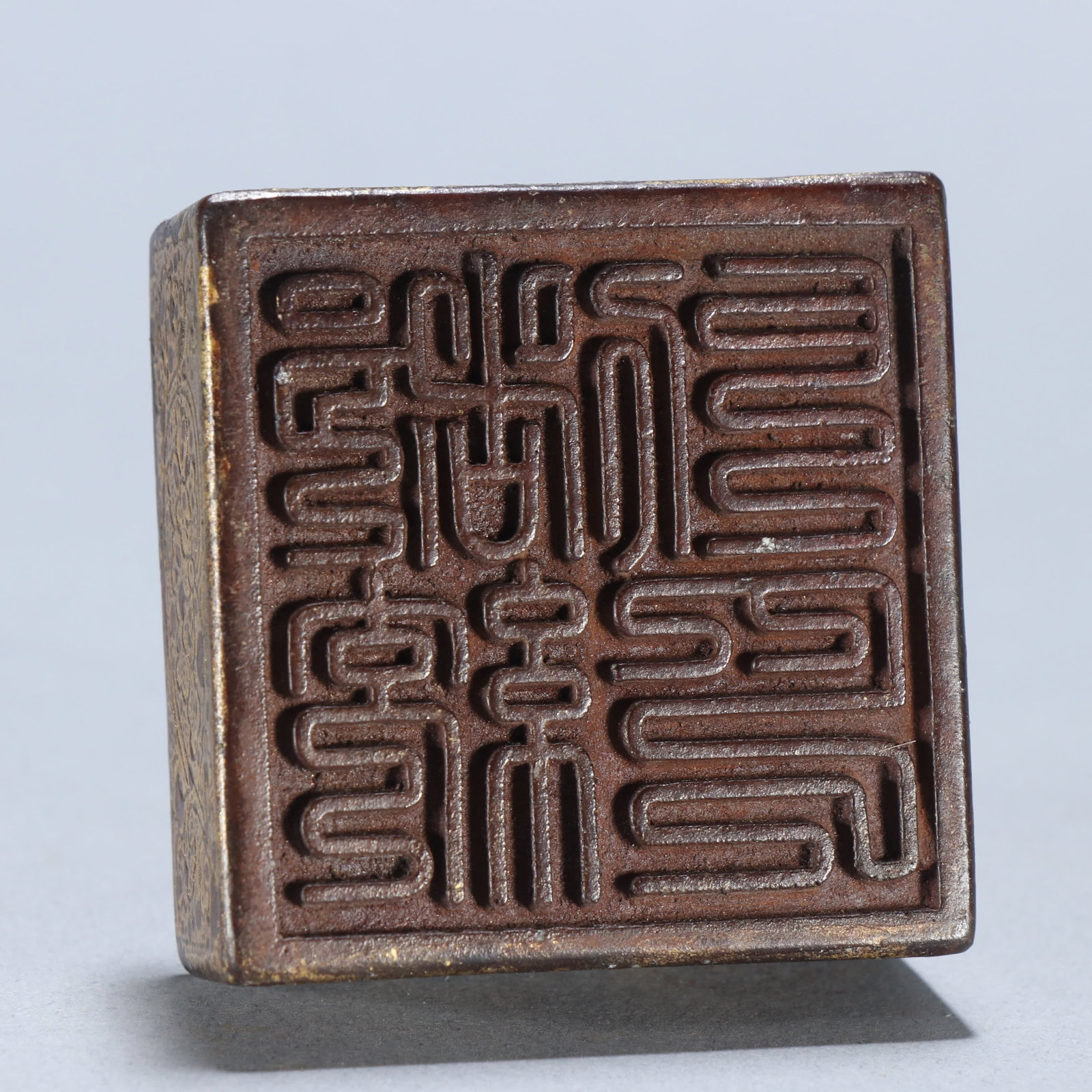 A copper gilt beast button seal - 9
