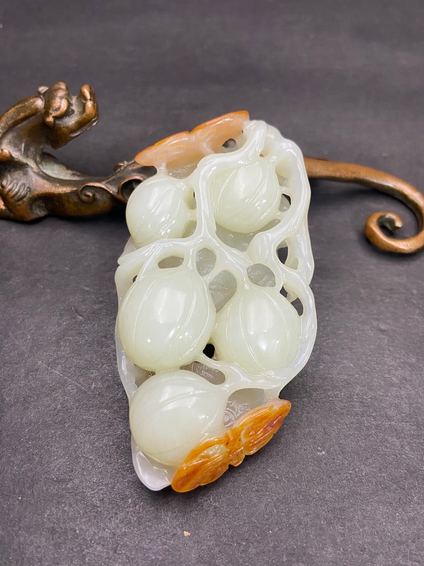 An Exquisite White Jade Melon and Fruit Pattern Hand Piece: An Exquisite White Jade Melon and Fruit Pattern Hand Piece Qing Dynasty, China Size:8.1cmx4.26cmx2.02cm Weight:82g (The Dimensions Of All Batches Are Manually Measured.If You Need More Detailed