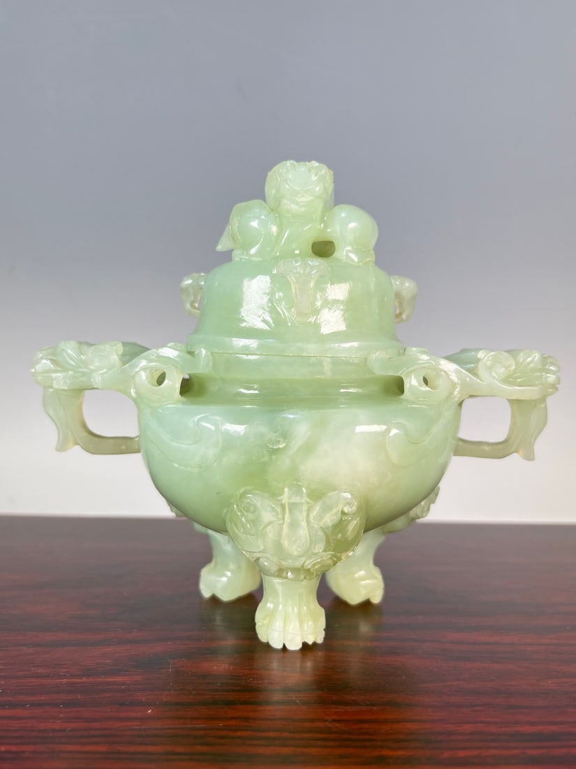 An Exquisite Serpentine Jade Beast-Face Pattern Double-Ears and Tripod Censer: An Exquisite Serpentine Jade Beast-Face Pattern Double-Ears and Tripod Censer Modern Time of China Size:15.5cmx17cm Weight:1347g (The Dimensions Of All Batches Are Manually Measured.If You Need More