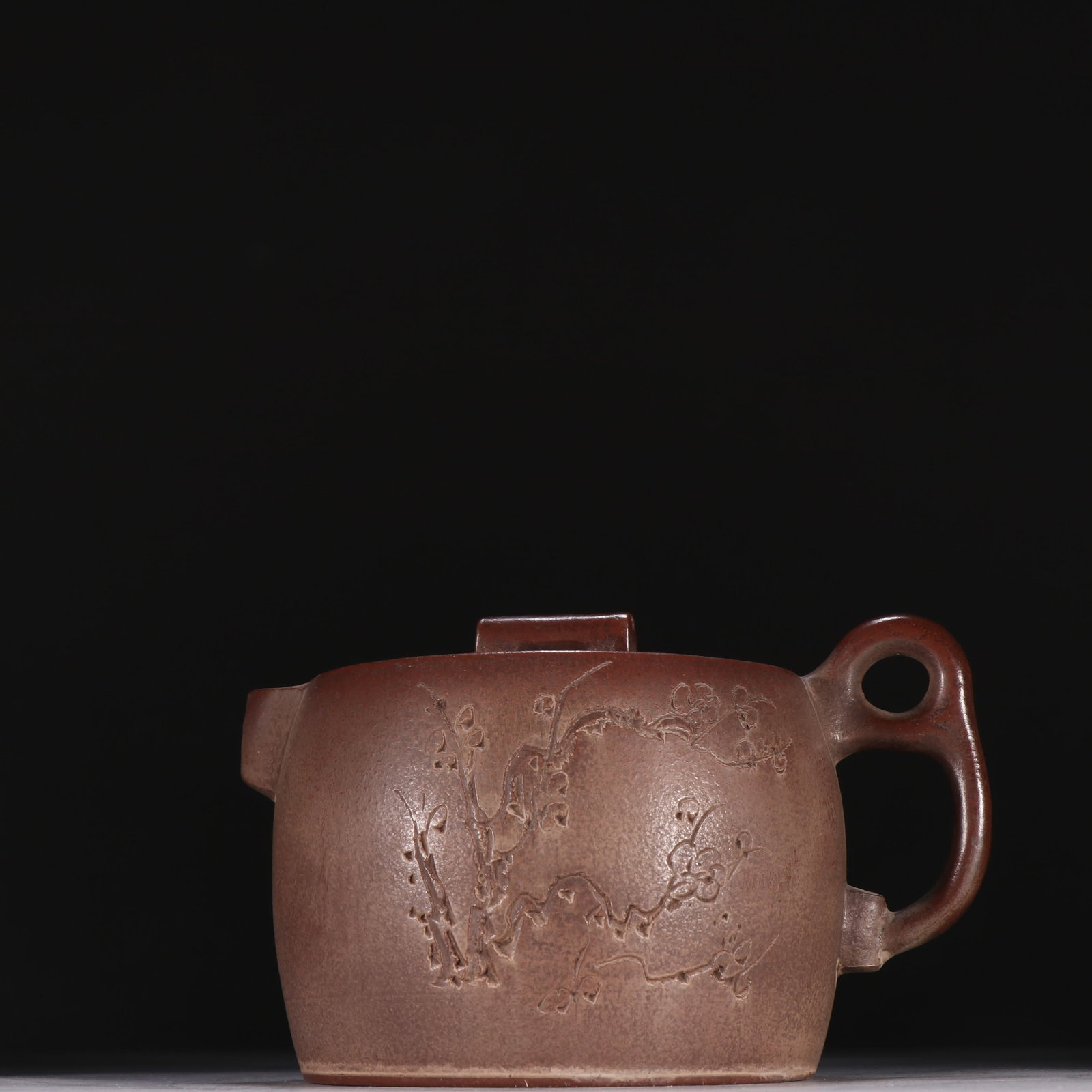 A Zhejiang Ning jade kiln made of purple sand plum pattern well railing teapot: Zhejiang Ning jade kiln made purple sand plum pattern well railing teapot SIZE: H:10cm W:15cm (The Dimensions Of All Batches Are Manually Measured.If You Need More Detailed Information, Please