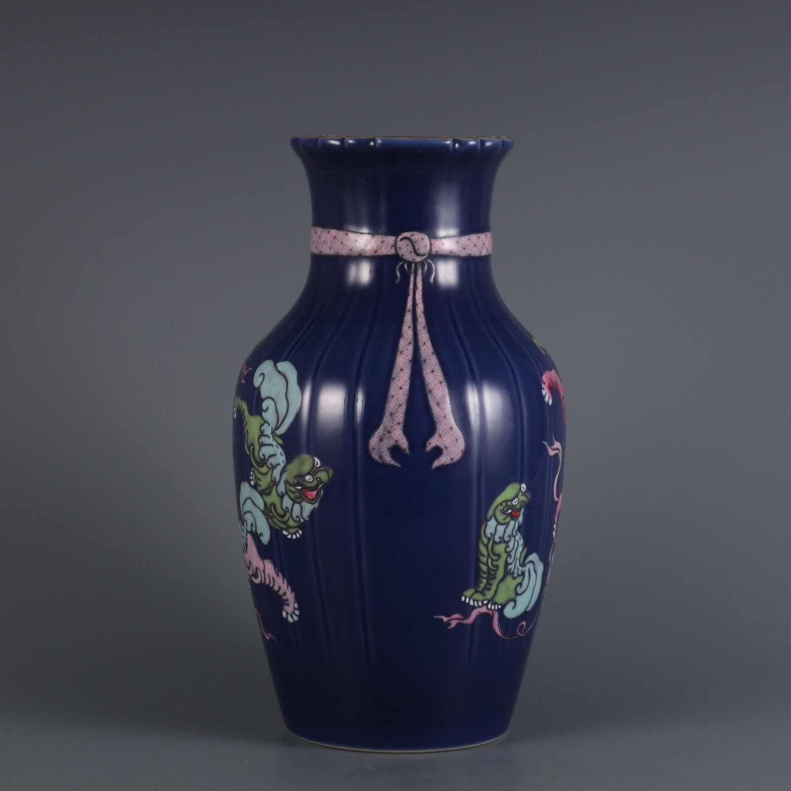 A Qing Dynasty Qianlong year Ji blue glaze plus pastel lion play ball melon ling streamer bottle: Qing Dynasty Qianlong year made clear blue glaze plus pastel lion play ball melon and ling streamer bottle SIZE: H:27.5cm MouthD:10cm (The Dimensions Of All Batches Are Manually Measured.If You Need