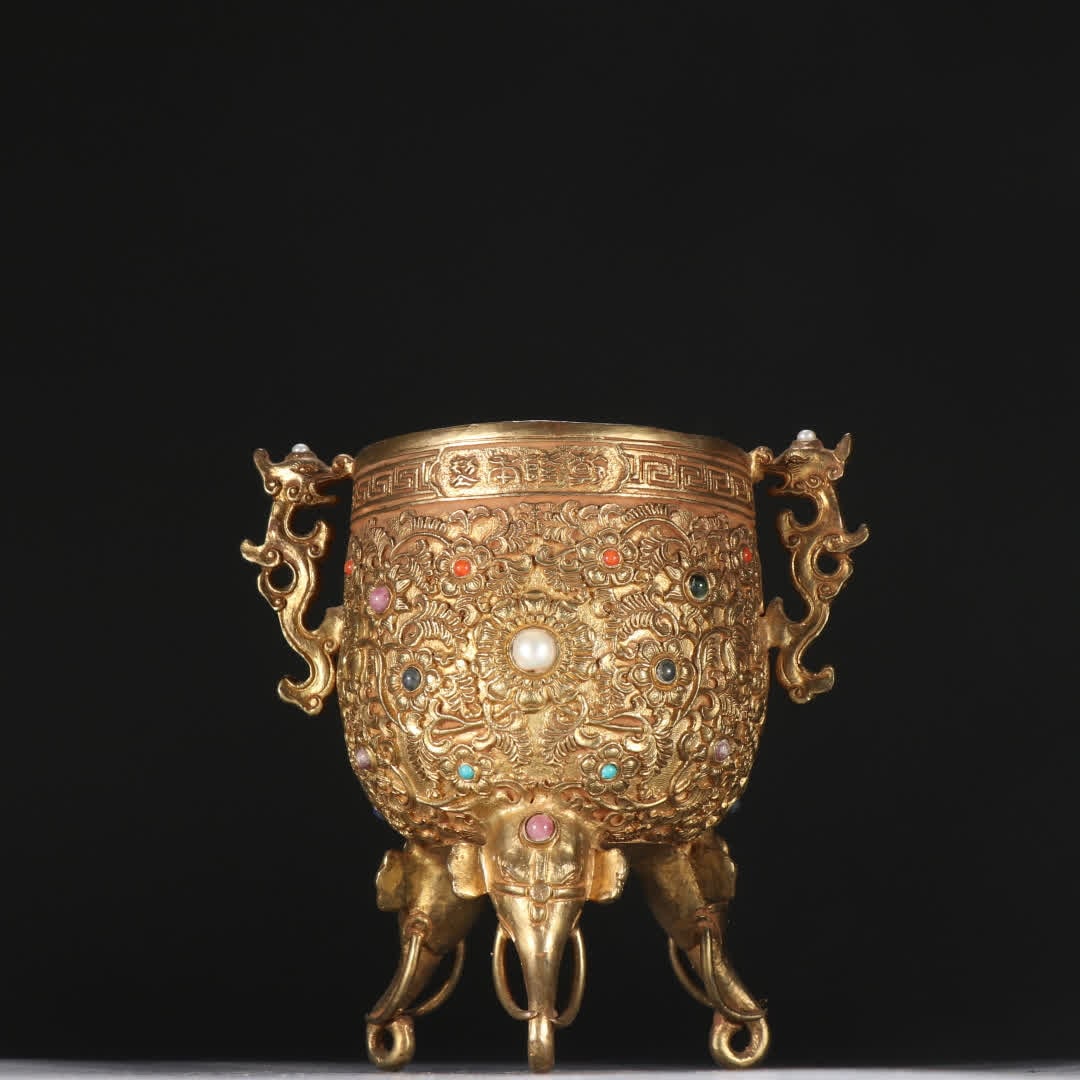 A Qing Dynasty copper-gilt three-legged Yonggu cup (1 of 9)