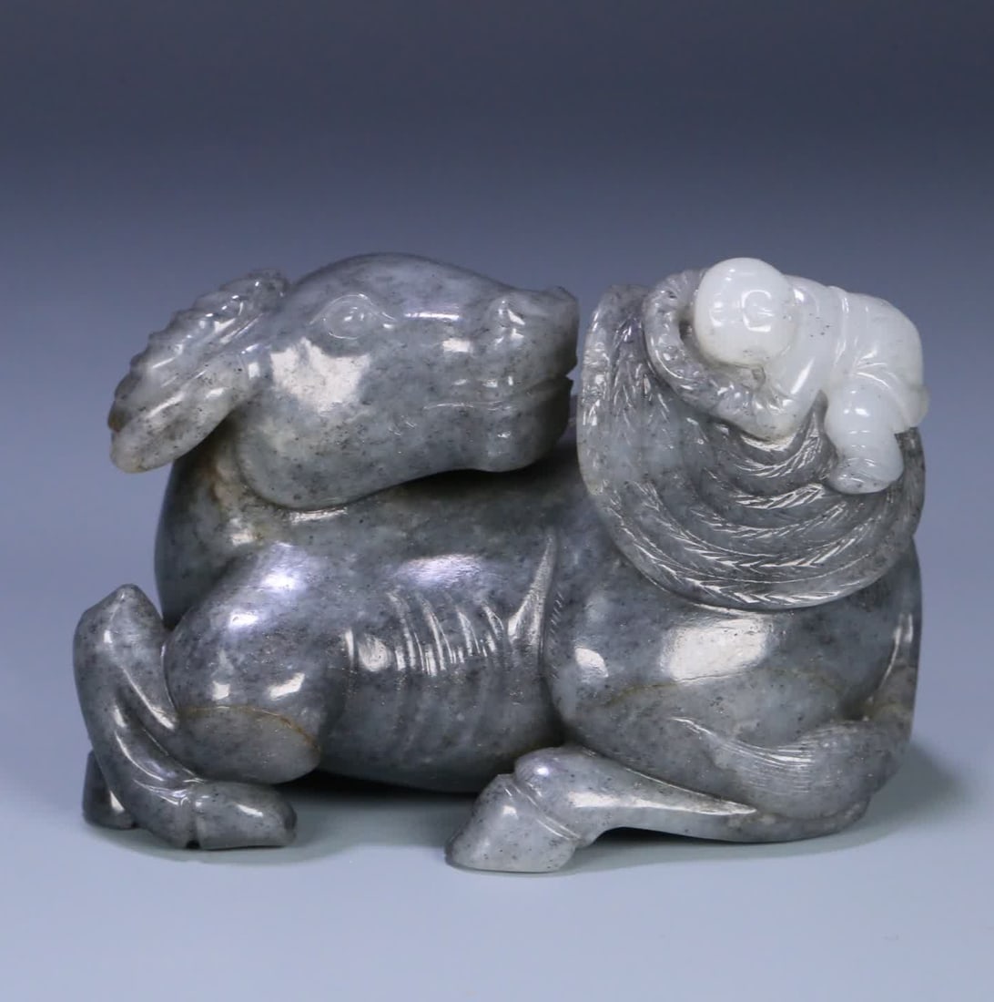 A Qing Dynasty Hetian jade blue and white seed material boy cattle herding ornament (1 of 9)