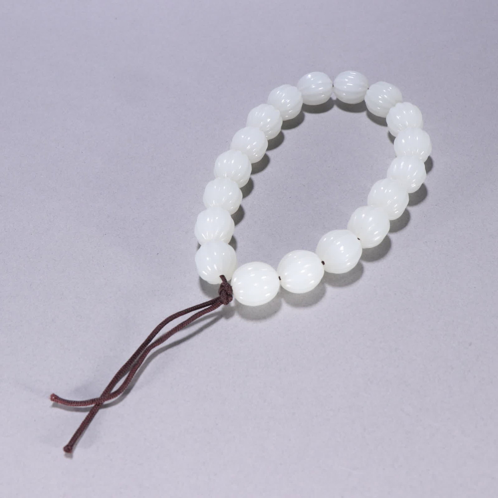 A Qing Dynasty Hetian jade melon edge bead eighteen sons held (1 of 9)